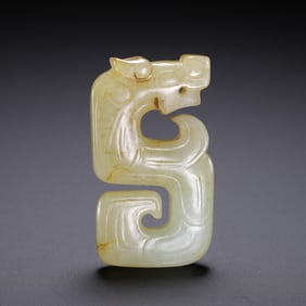 A WHITE JADE DRAGON CARVING