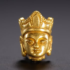 A GOLD GUARDIAN HEAD