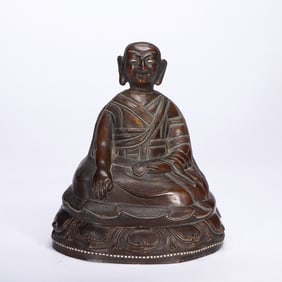 A SILVER INLAID BRONZE SEATED LAMA