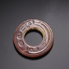 A CHINESE ARCHAISTIC JADE DISC BI