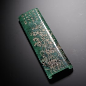 AN INCISED SPINACH GREEN JADE WRIST-REST