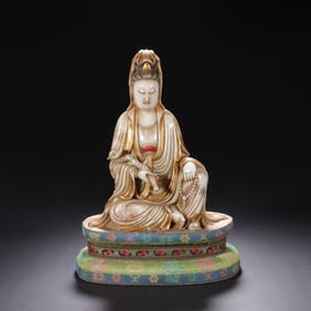 A CARVED SHOUSHAN STONE SEATED GUANYIN