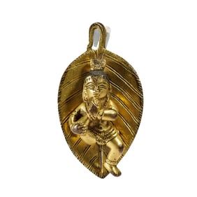 A BRONZE-GILT YOGINI PENDANT