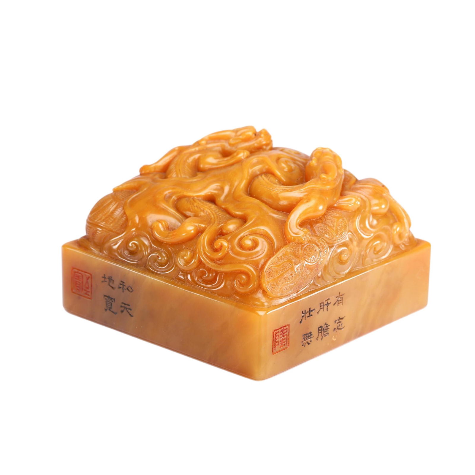 A CARVED TIANHUANG CHILONG GROUP SEAL: A CARVED TIANHUANG CHILONG GROUP SEAL This square seal is masterfully carved from a single piece of fine Tianhuang stone, renowned for its rich, honey-yellow hue and smooth, waxy luster. The top is ex