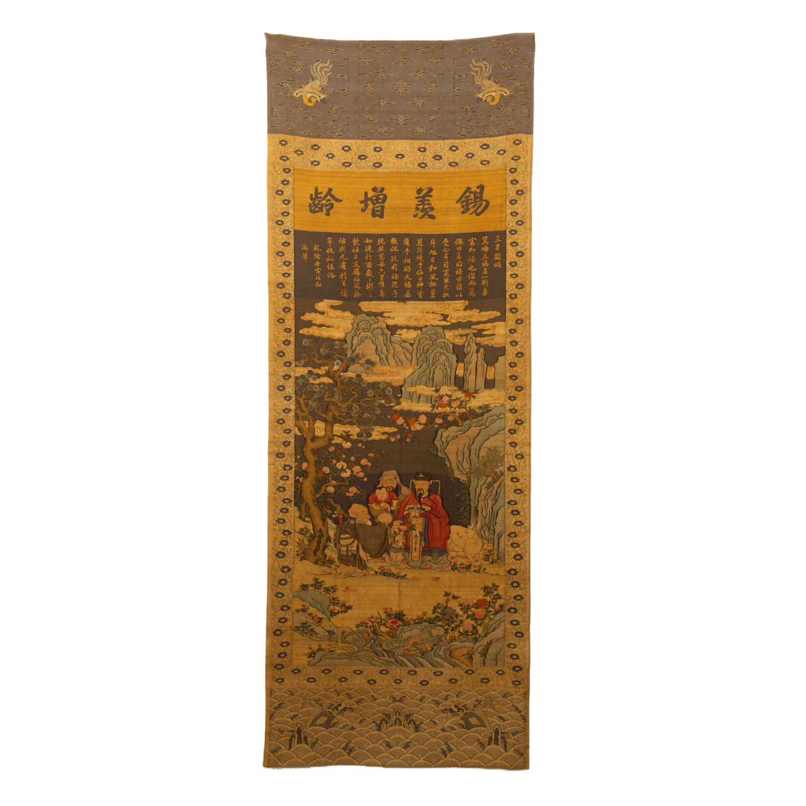 A KESI EMBROIDERED THREE STARS OF GODS HANGING PANEL: A KESI EMBROIDERED THREE STARS OF GODS HANGING PANEL A large Chinese kesi scroll, featuring the Three Star Immortals (Fu, Lu, Shou) in a landscape of pines, rocks, and flowering branches. The top bear