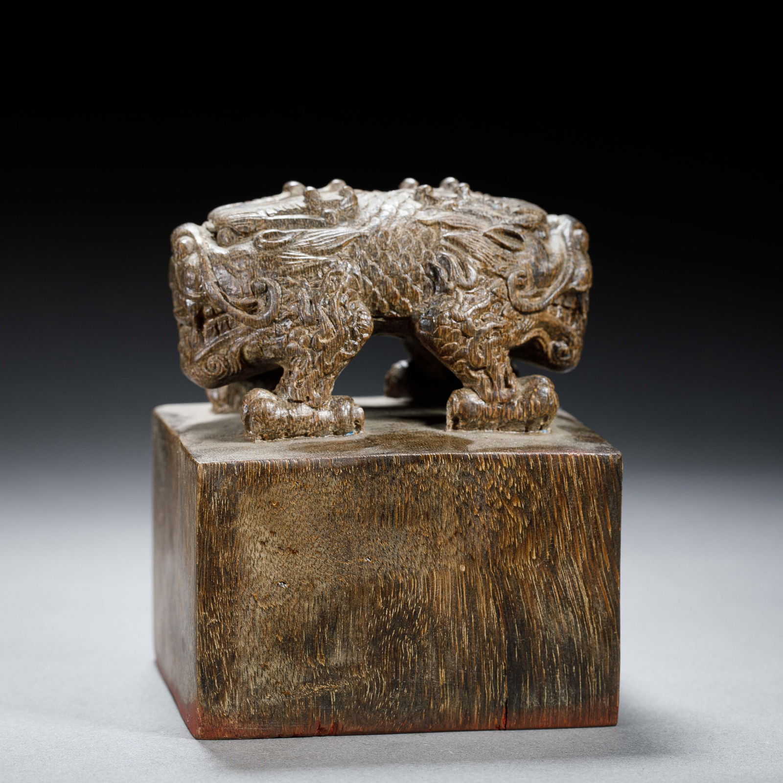 A RARE CARVED ALOESWOOD CHENXIANG SEAL: A RARE CARVED ALOESWOOD CHENXIANG SEAL This exceptional seal is carved from a single piece of rare, high-grade agarwood, displaying its characteristic dark, mottled grain and rich, aromatic patina. Th