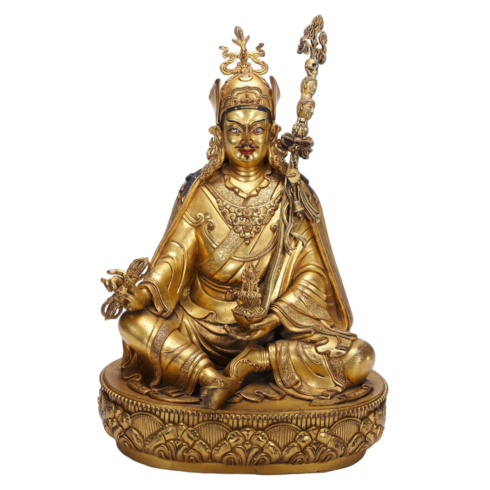 A BRONZE-GILT FIGURE OF PADMASAMBHAVA: A BRONZE-GILT FIGURE OF PADMASAMBHAVA This commanding Chinese gilt bronze figure depicts Padmasambhava, the revered "Lotus-Born" master of Tibetan Buddhism. Seated in a relaxed lalitasana pose, he