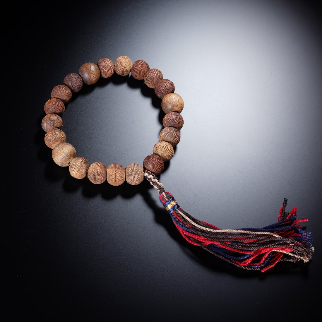 A CHINESE ALOESWOOD CHENXIANG PRAYER BEADS: A CHINESE ALOESWOOD CHENXIANG PRAYER BEADS An elegant Chinese eighteen-bead prayer bracelet, crafted from rare, fragrant agarwood. Each bead is meticulously carved with a classic 'fu' (fortune)