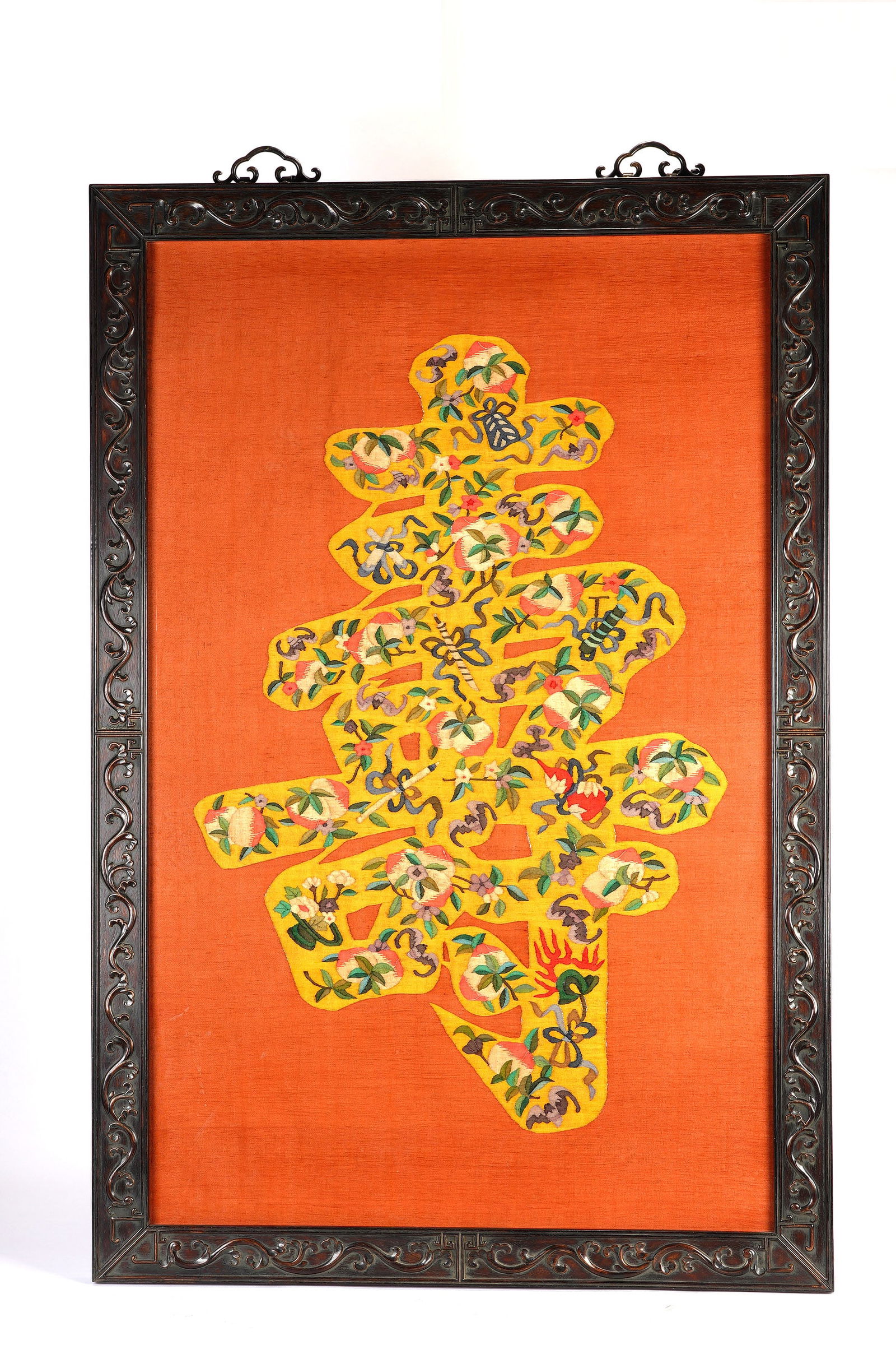 A CHINESE IMPERIAL KESI EMBROIDERED LONGEVITY SHOU HANGING PANEL: A CHINESE IMPERIAL KESI EMBROIDERED LONGEVITY SHOU HANGING PANEL A magnificent Chinese kesi hanging screen, centered on a large, vibrant yellow character "shou" (longevity), intricately embroidered