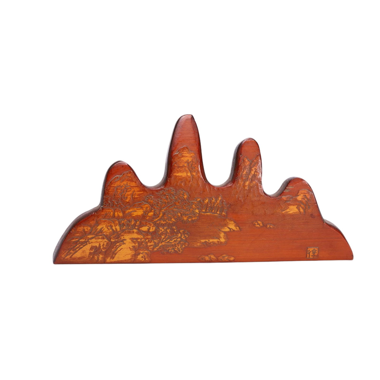 A CARVED BAMBOO BRUSHREST: A CARVED BAMBOO BRUSHREST This Chinese brush rest is crafted from bamboo huang (bamboo pith), shaped into a classic five-peaked mountain form. The surface is intricately incised with a detailed landsc