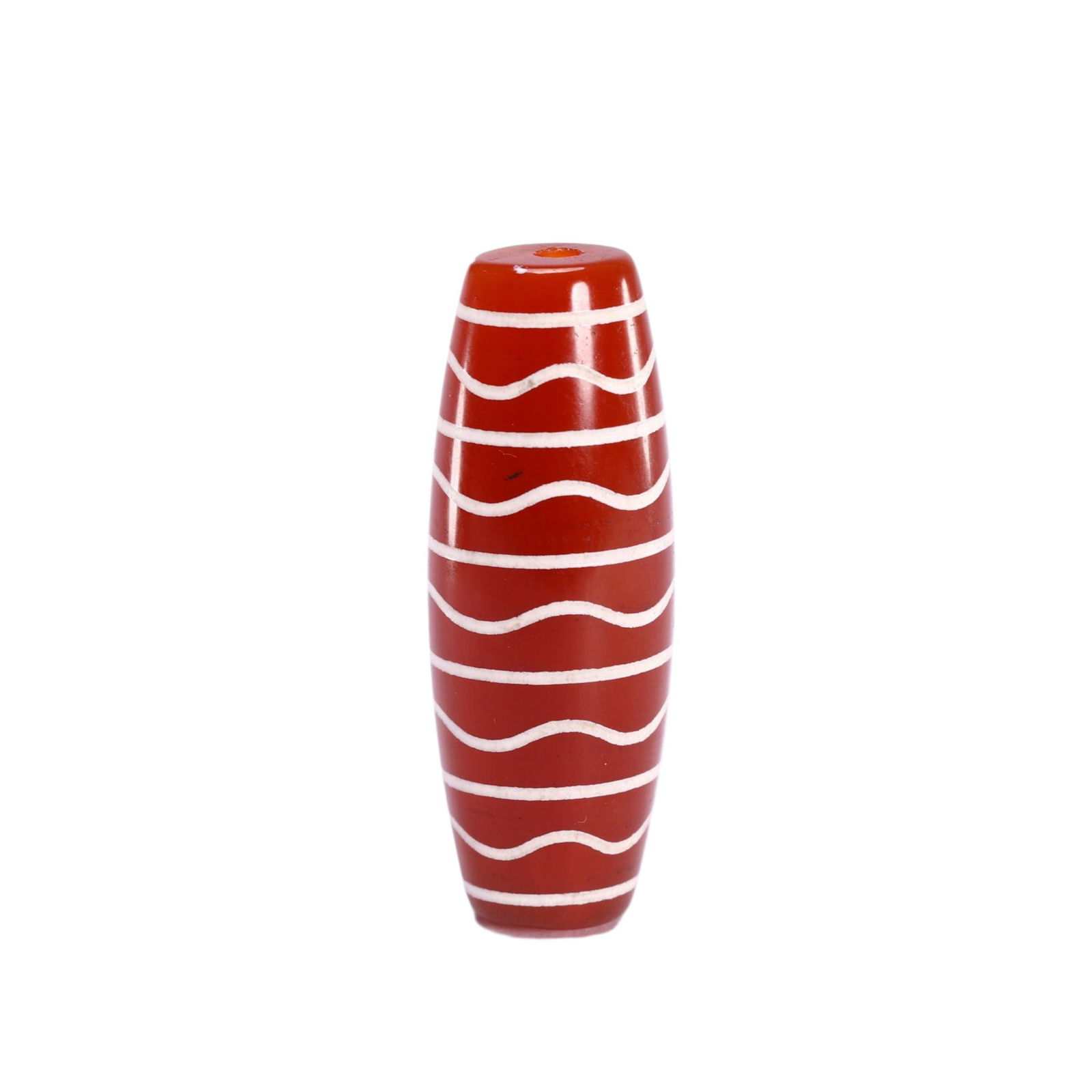 A TIBETAN DZI BEAD: A TIBETAN DZI BEAD This fine Chinese carnelian dzi bead features a rich, translucent orange-red hue, with a smooth, polished surface that reflects light beautifully. It is decorated with alternating