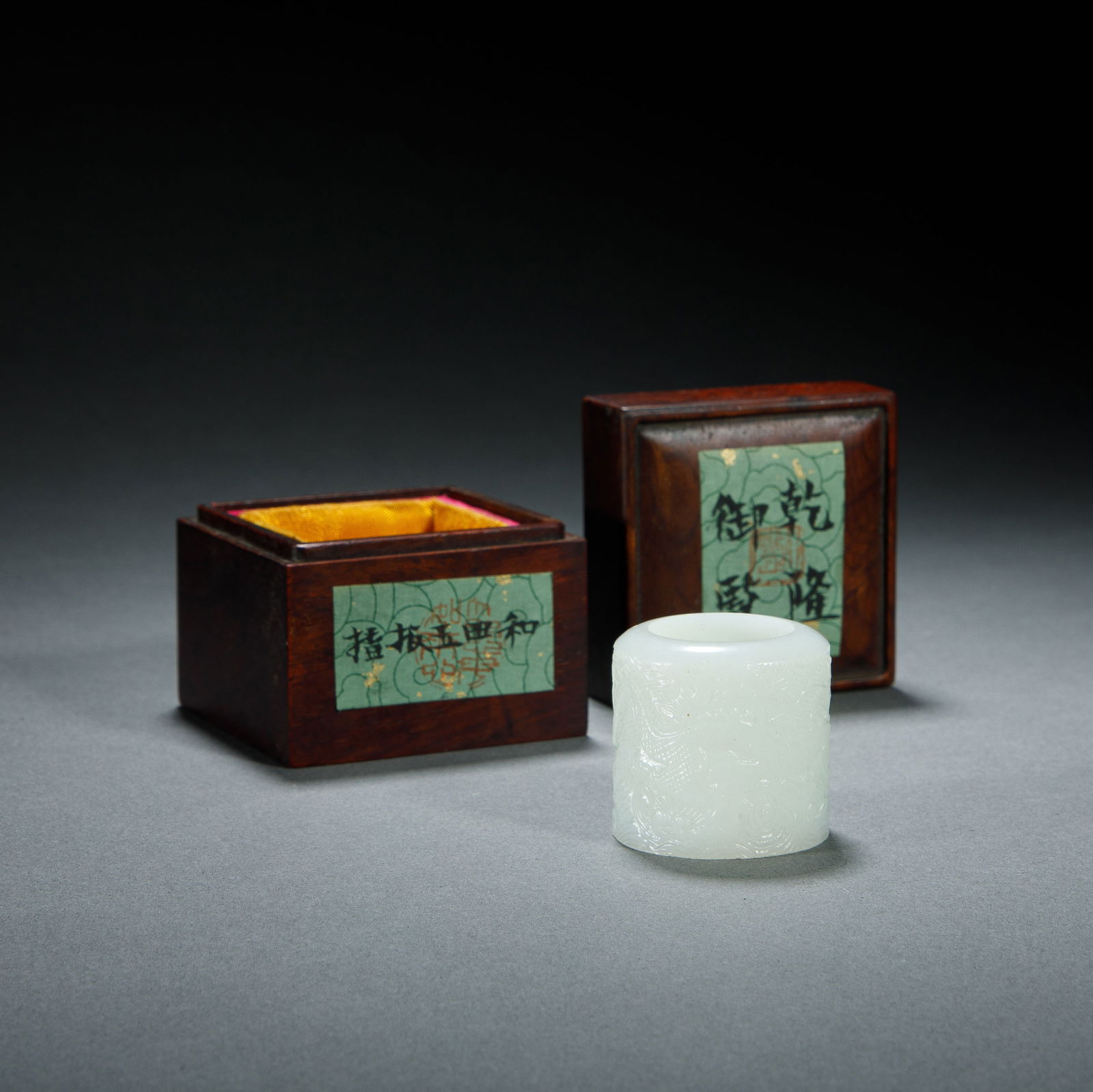 A CARVED WHITE JADE ARCHER RING: A CARVED WHITE JADE ARCHER RING This superb archer's thumb ring is carved from a single piece of luminous, white Hetian jade of exceptional quality. Its cylindrical surface is masterfully carved in lo