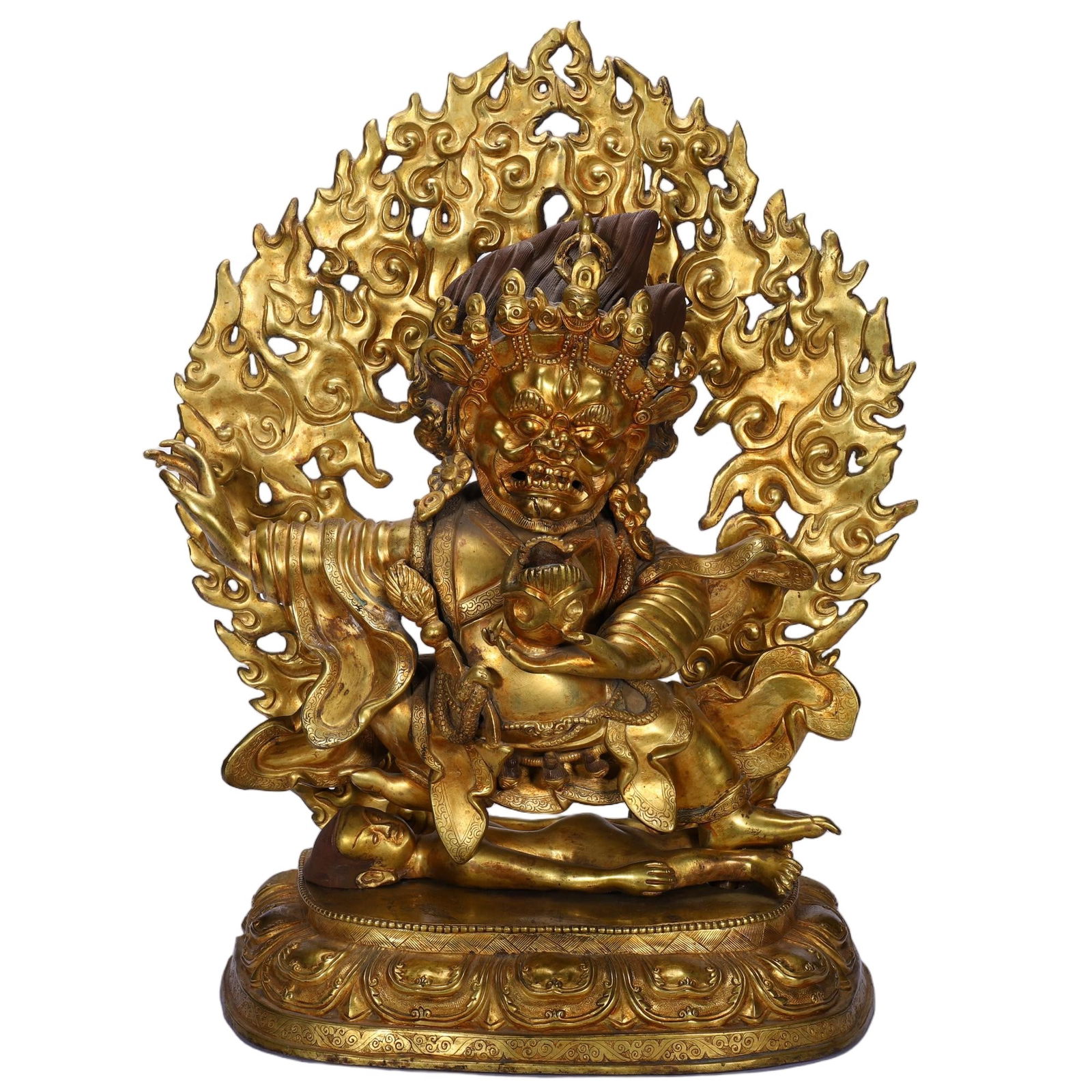 A BRONZE-GILT FIGURE OF PANJARNATA MAHAKALA: A BRONZE-GILT FIGURE OF PANJARNATA MAHAKALA This powerful Chinese gilt bronze figure depicts Mahakala, the wrathful protector in Tibetan Buddhism. The deity is shown in a dynamic pose, trampling a pro