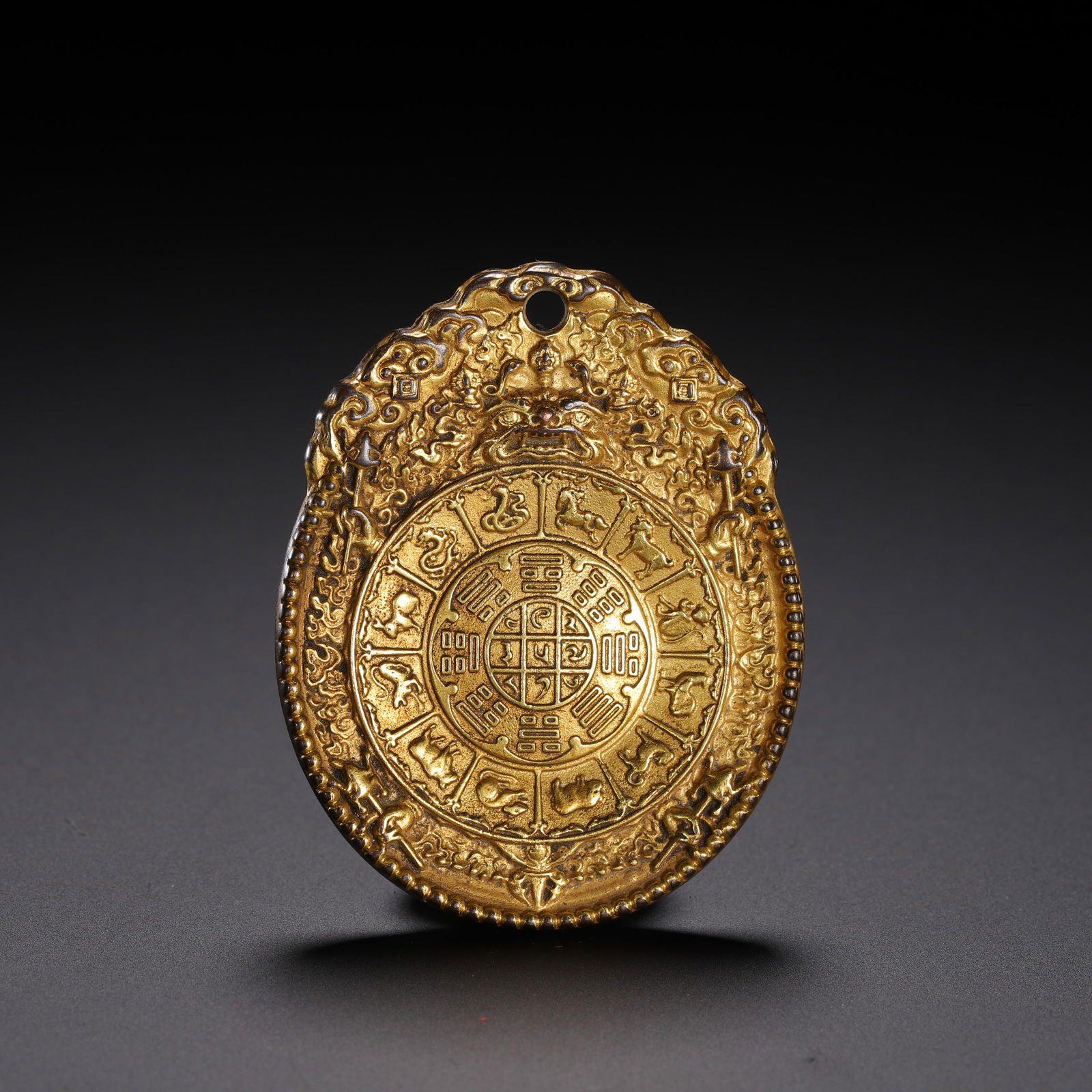 A TIBETANBRONZE-GILT AMULET (1 of 9)