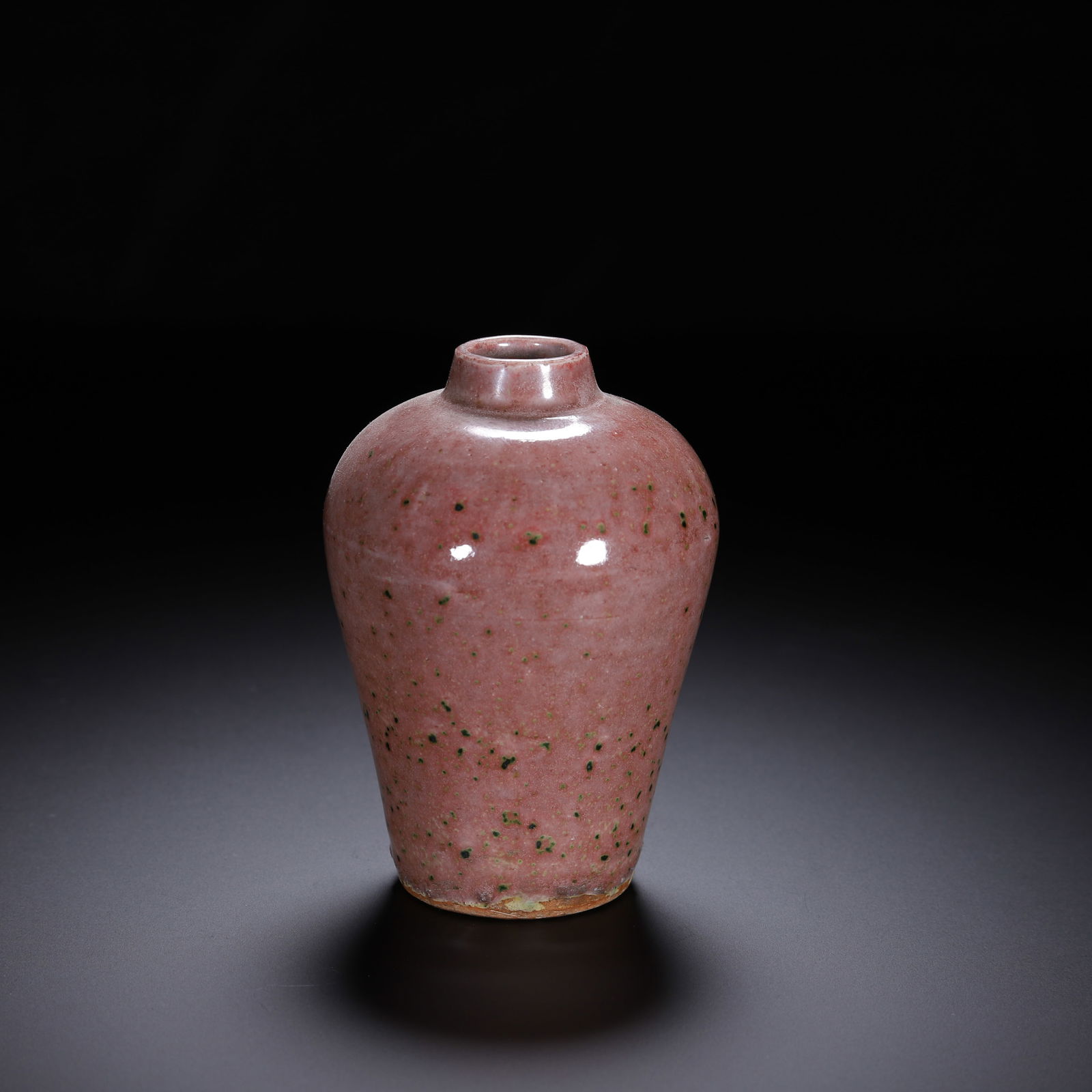 A PEACH BLOOM GLAZE: A PEACH BLOOM GLAZE A Chinese cowpea red glazed meiping vase, with a compact, elegant form: a short, slightly flared neck, a rounded shoulder, and a tapering body terminating in a small, unglazed foot