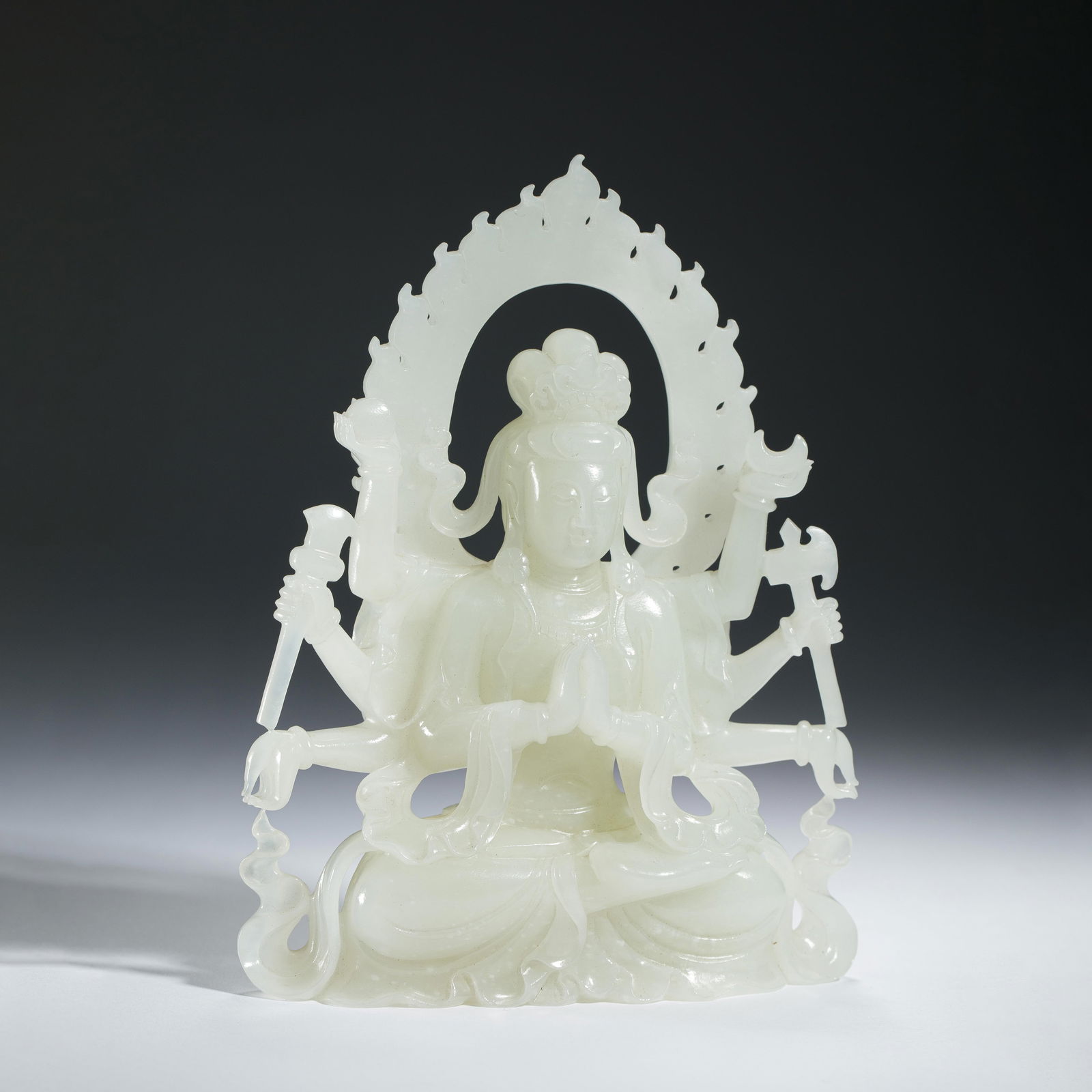 A FINE CARVED WHITE JADE SEATED BODHISATTVA (1 of 9)