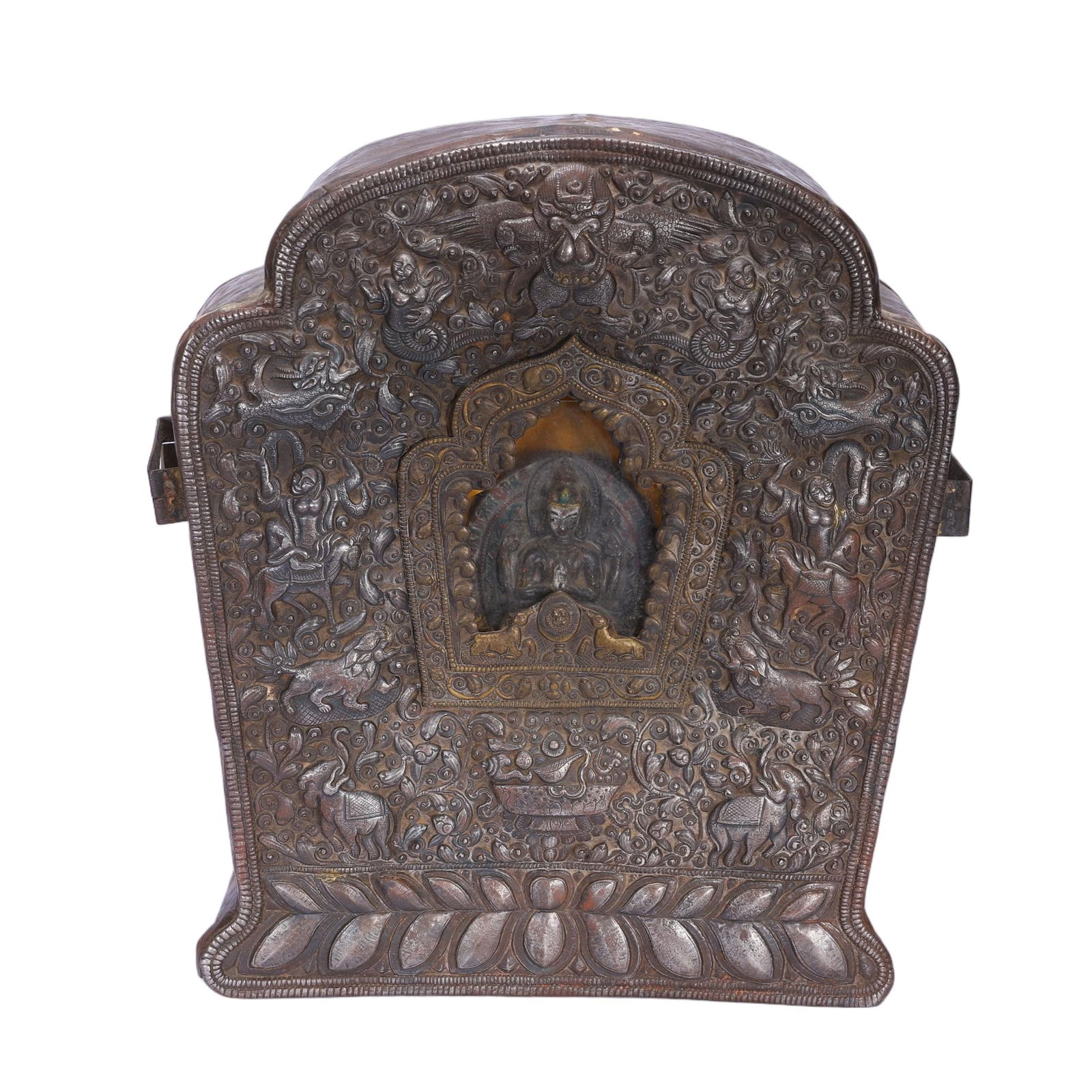 A TIBETAN BRONZE SHRINE GAU: A TIBETAN BRONZE SHRINE GAU This monumental Tibetan gau box is richly repoussé-decorated with intricate relief work. The front features a central arched niche enclosing a seated Buddha, surrounded