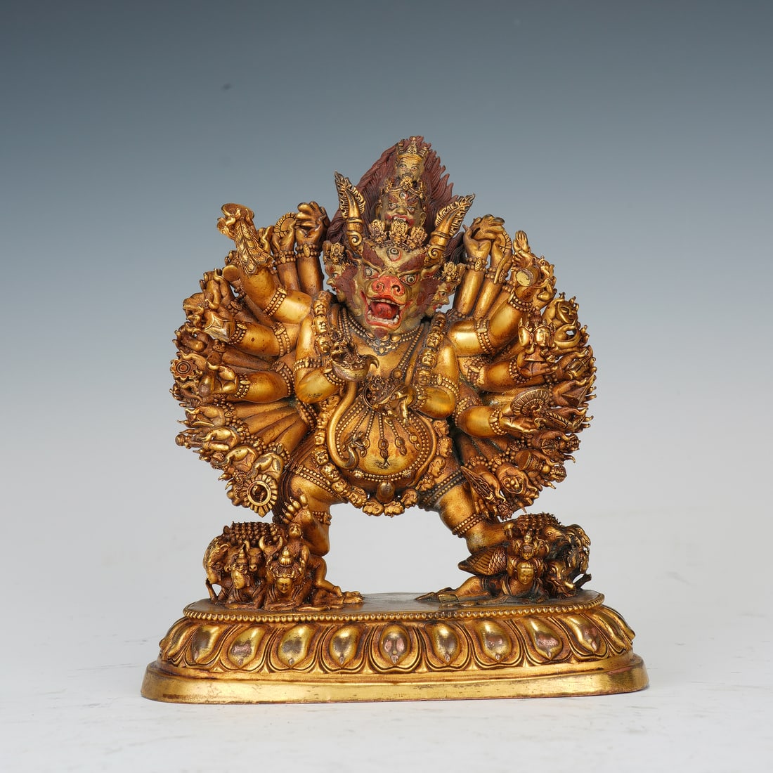 A SINO-TIBETAN BRONZE-GILT FIGURE OF YAMANTAKA: A SINO-TIBETAN BRONZE-GILT FIGURE OF YAMANTAKA A powerful and dynamically cast Chinese gilt-bronze figure of Yamantaka, the Destroyer of Death, a principal protector deity in Tibetan Buddhism. This