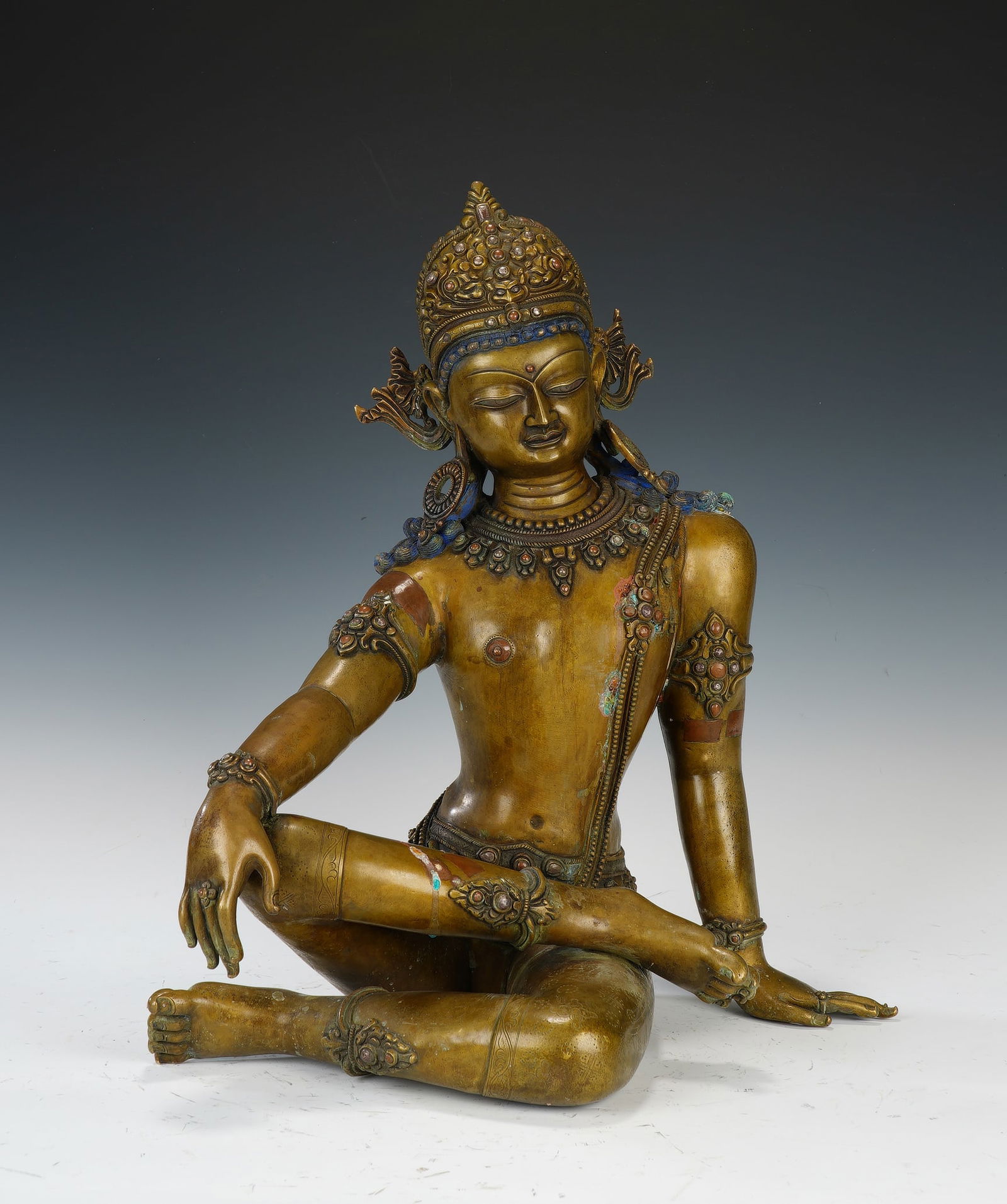 A COPPER ALLOY FIGURE OF INDRA: A COPPER ALLOY FIGURE OF INDRA Indra is the lord of the gods who plays an important part in the legends, life and art of Nepal, and the best that the Newari sculptor had to give often went into the