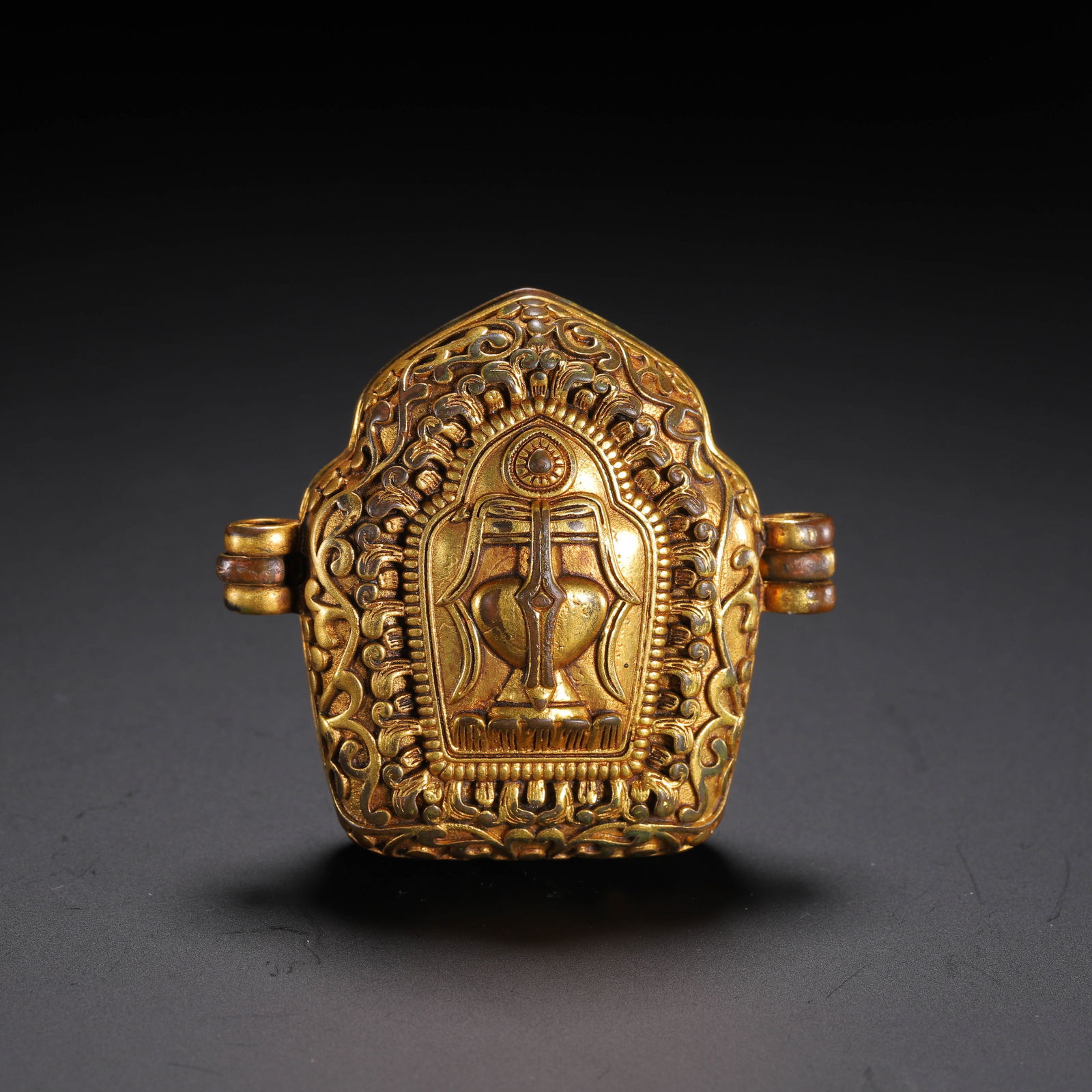 A TIBETAN BRONZE-GILT AMULET BOX (1 of 9)