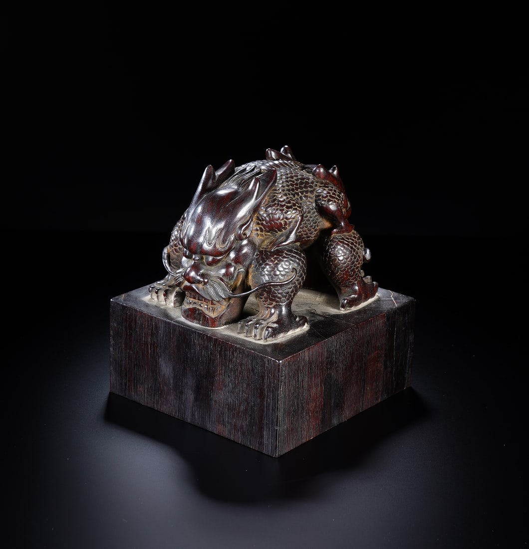 A CARVED ROSEWOOD ZITAN DRAGON SEAL: A CARVED ROSEWOOD ZITAN DRAGON SEAL A magnificent and imposing Chinese seal, carved from highly prized zitan wood, renowned for its deep, lustrous blackish-purple hue and fine grain. The substantial s