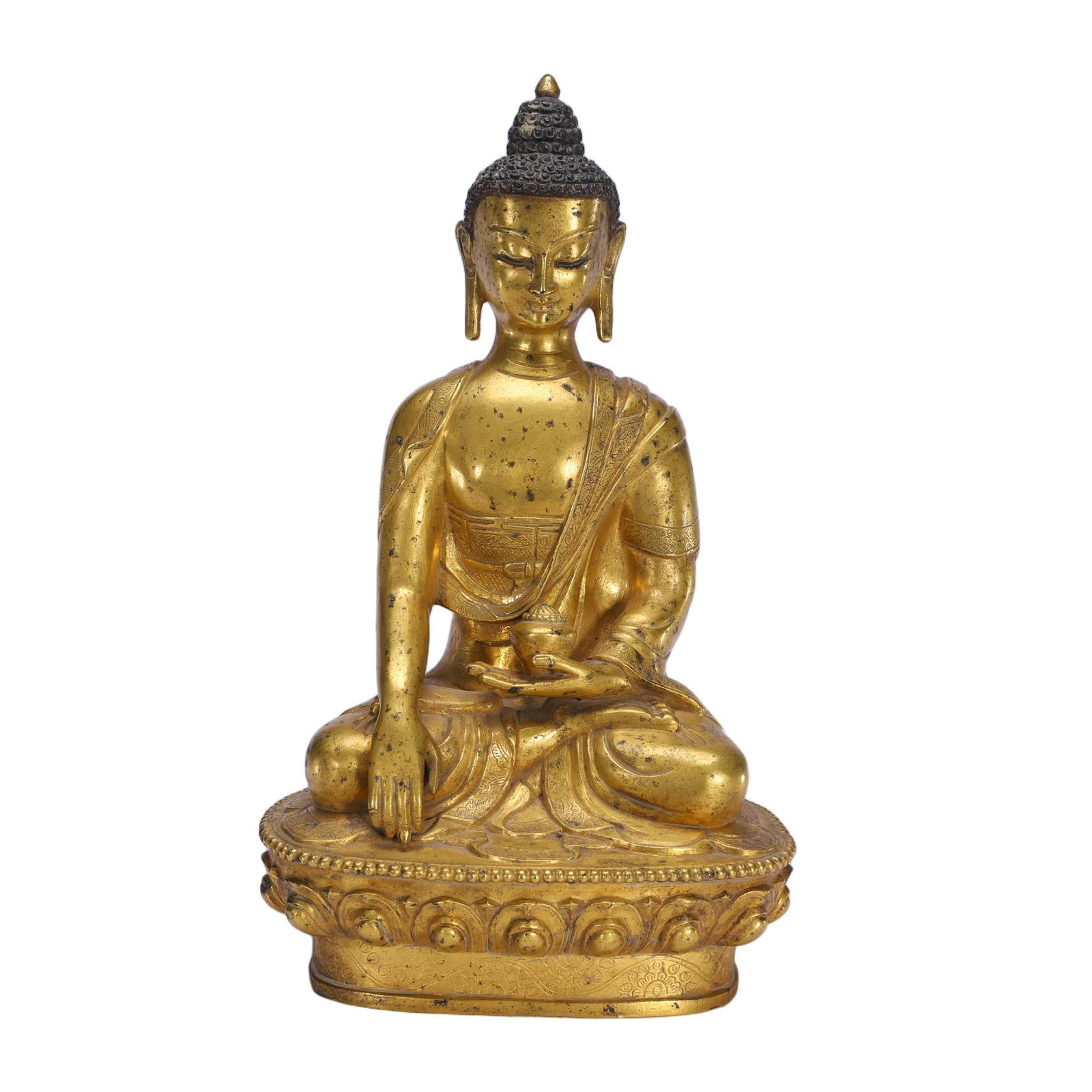A BRONZE-GILT FIGURE OF SHAKYAMUNI: A BRONZE-GILT FIGURE OF SHAKYAMUNI This serene figure is cast in gilt-bronze, seated in the lotus position on a double-lotus base. The right hand extends in the bhumisparsha mudra, touching the