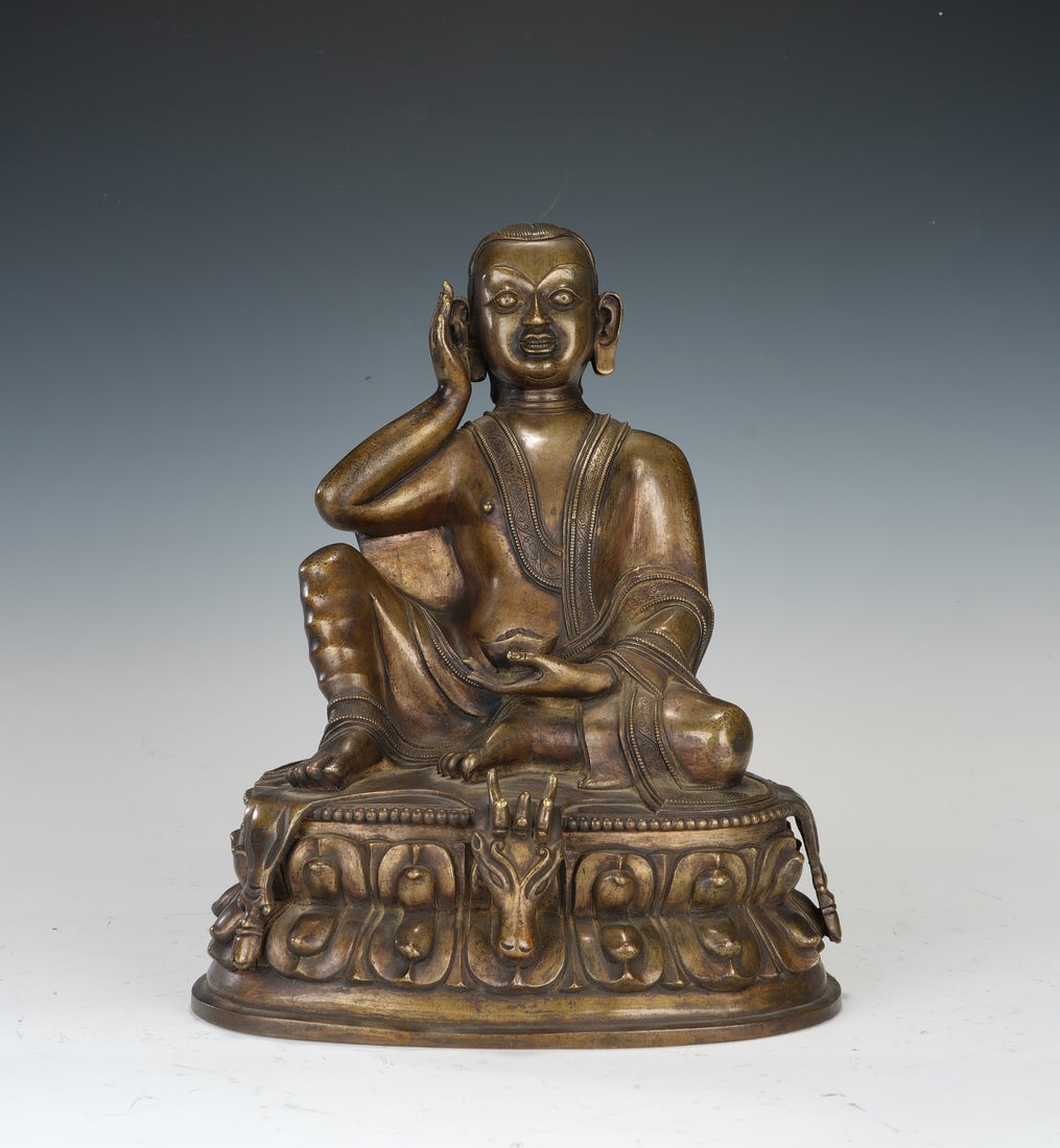 A TIBETAN COPPER ALLOY SEATED MILAREPA (1 of 8)