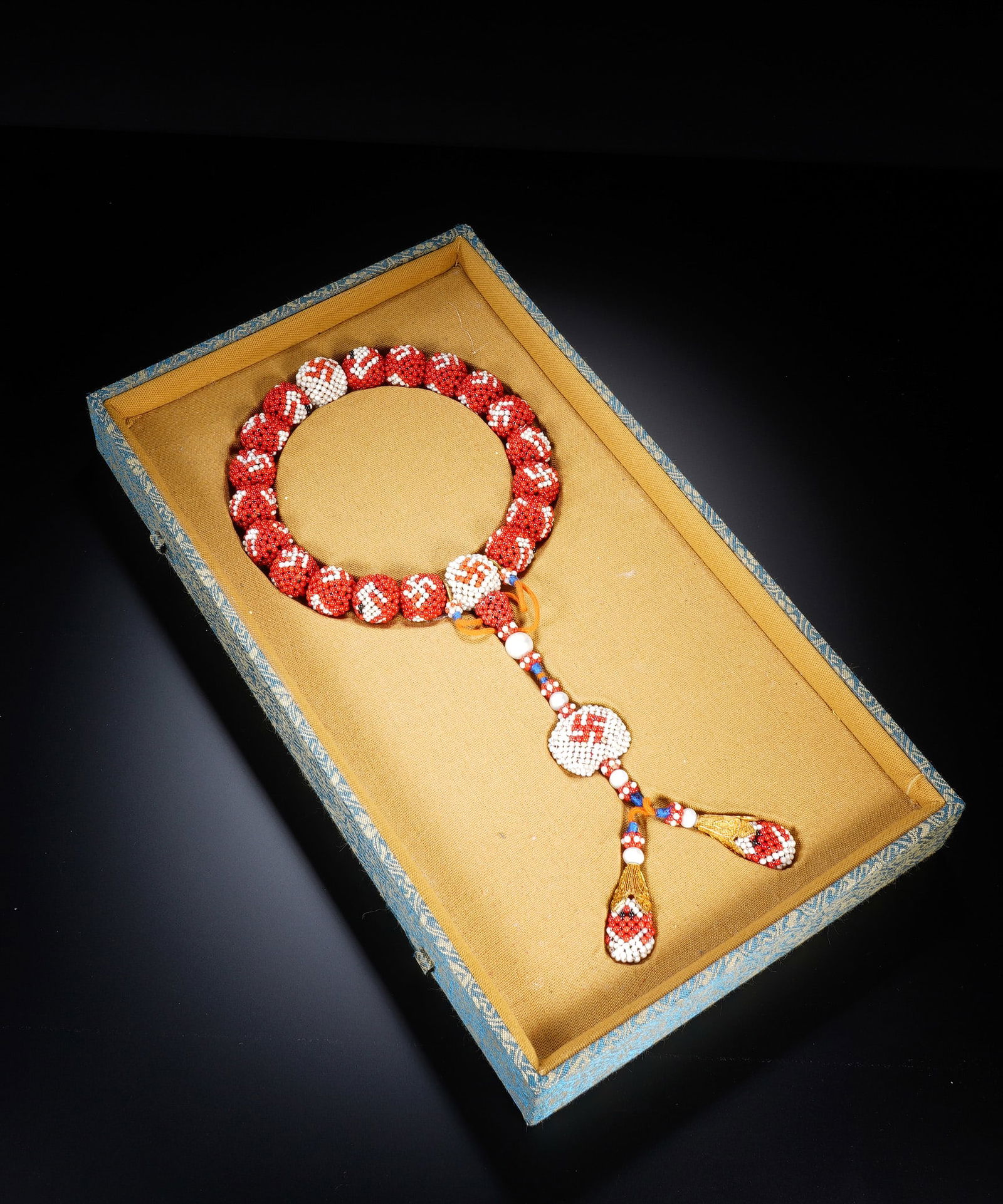A CHINESE IMPERIAL WEAVED PRAYER BEADS SHOUCHUAN: A CHINESE IMPERIAL WEAVED PRAYER BEADS SHOUCHUAN An opulent and rare Chinese court prayer bracelet, meticulously handcrafted from countless tiny red coral and white seed beads woven into larger spheri