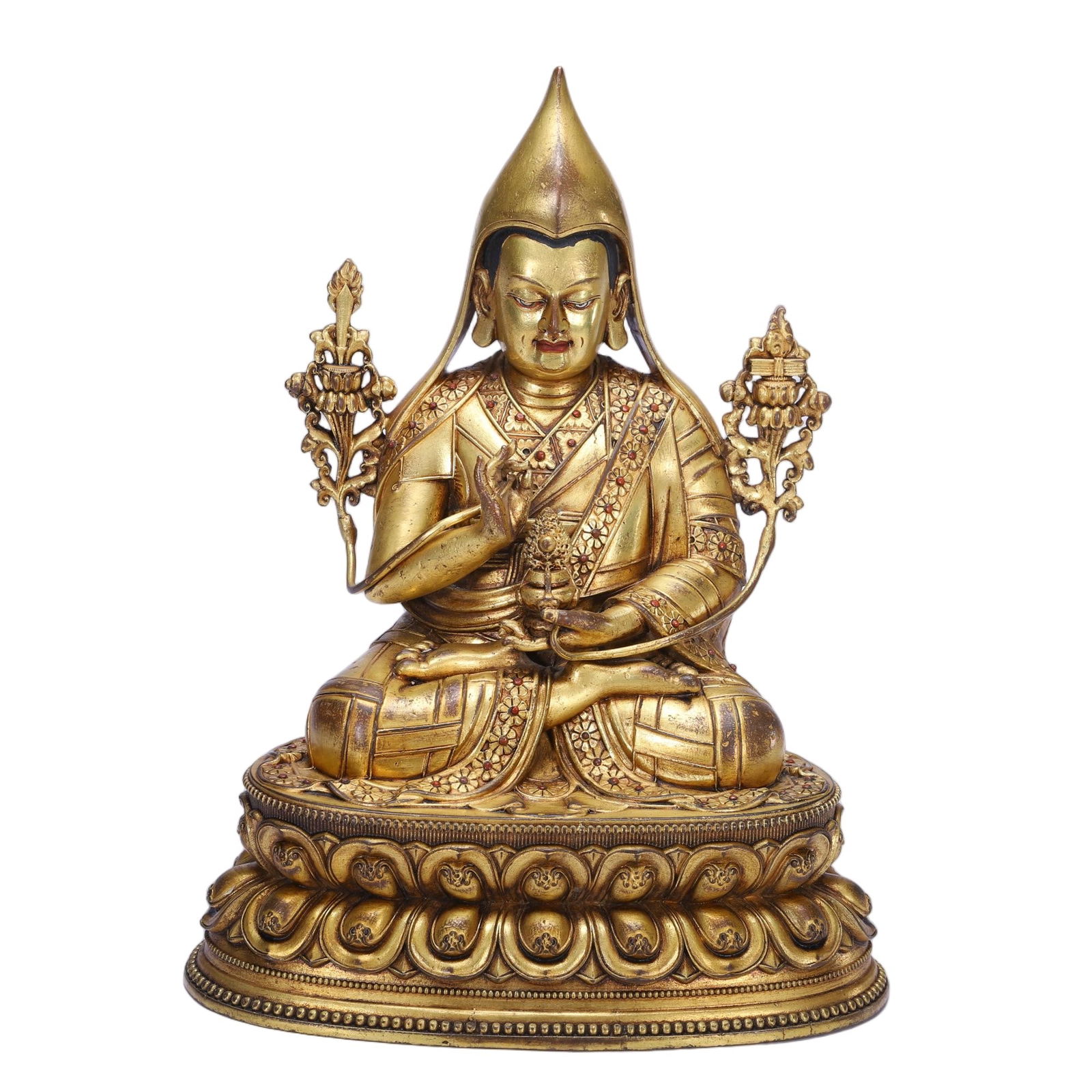A BRONZE-GILT FIGURE OF TSONG KHAPA: A BRONZE-GILT FIGURE OF TSONG KHAPA This serene Chinese gilt bronze figure depicts Tsongkhapa, the revered founder of the Gelug school of Tibetan Buddhism, seated in the lotus position atop a double-l