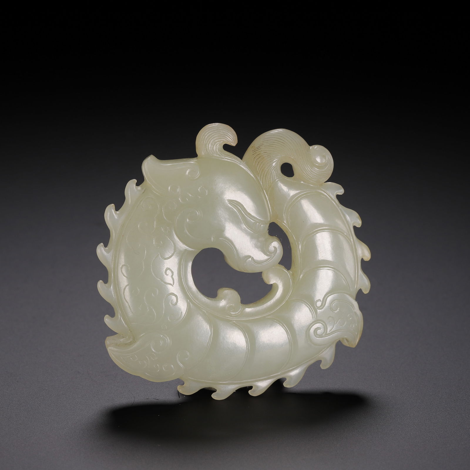 A CARVED WHITE JADE DRAGON (1 of 9)