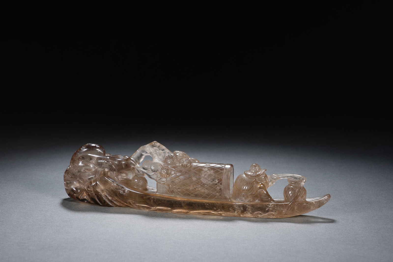 A CARVED ROCK CRYSTAL BOAT: A CARVED ROCK CRYSTAL BOAT An exquisite Chinese carving, masterfully rendered from a single piece of smoky rock crystal. The work depicts a traditional fishing boat gliding upon stylized waves,