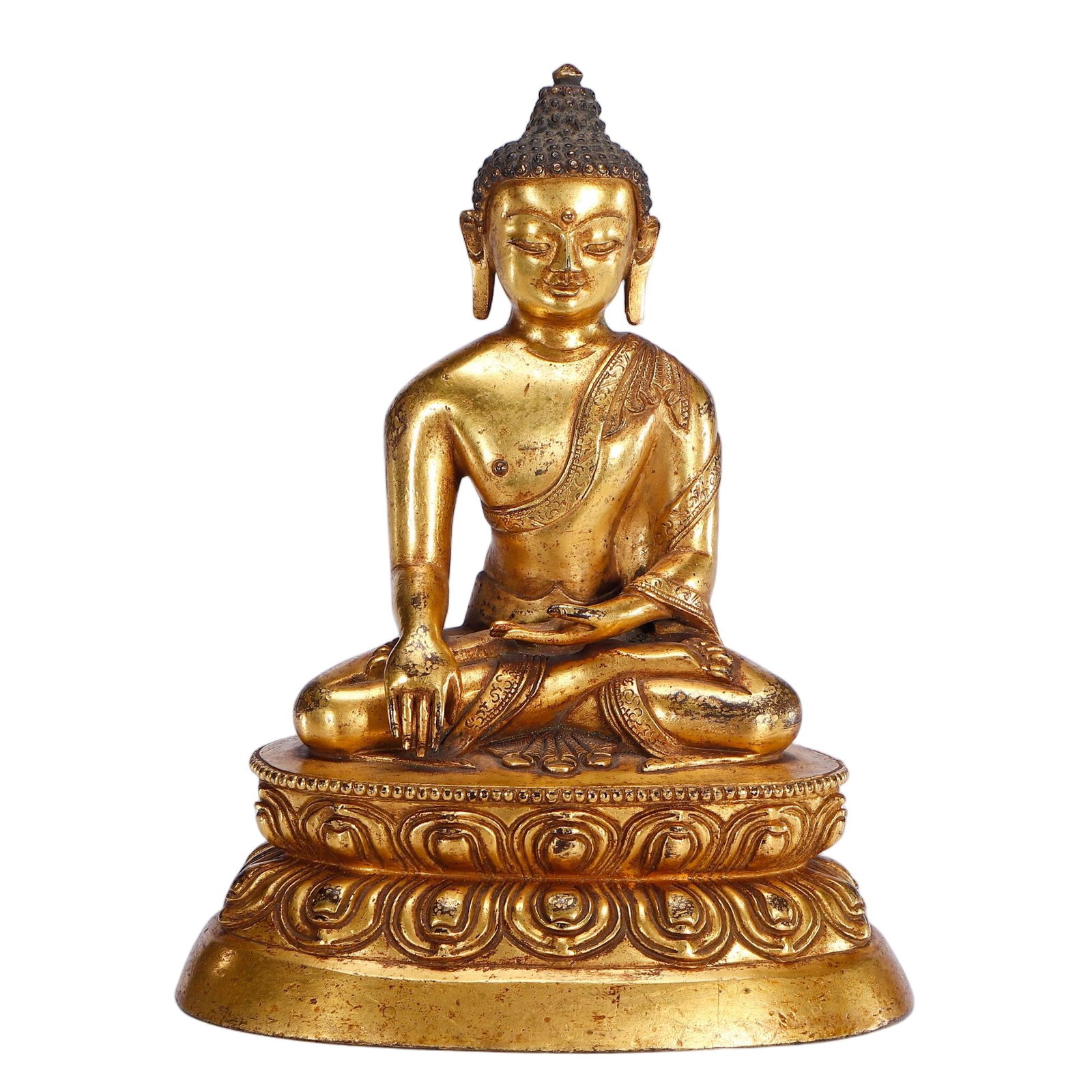 A BRONZE-GILT FIGURE OF SHAKYAMUNI: A BRONZE-GILT FIGURE OF SHAKYAMUNI This Chinese Buddha is cast from gilt-bronze, seated in the lotus position on a double-lotus pedestal. The right hand touches the earth in the bhumisparsha mudra, wh