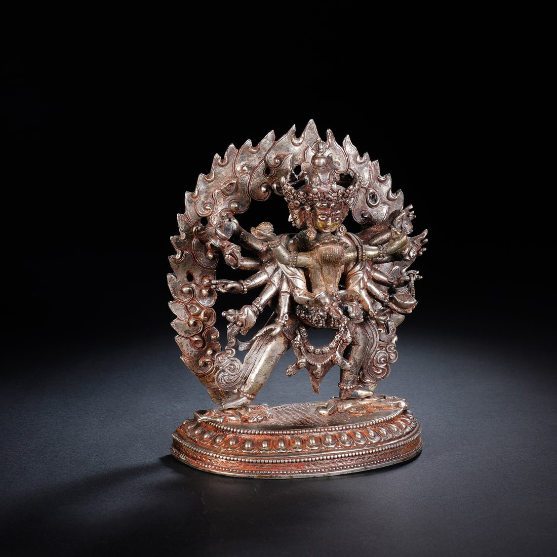 A SILVER FIGURE OF CAKRASAMVARA: A SILVER FIGURE OF CAKRASAMVARA A powerful and dynamic silver figure of Yamantaka, the wrathful manifestation of Manjushri, the Bodhisattva of Wisdom. The multi-armed deity is depicted in a fierce,
