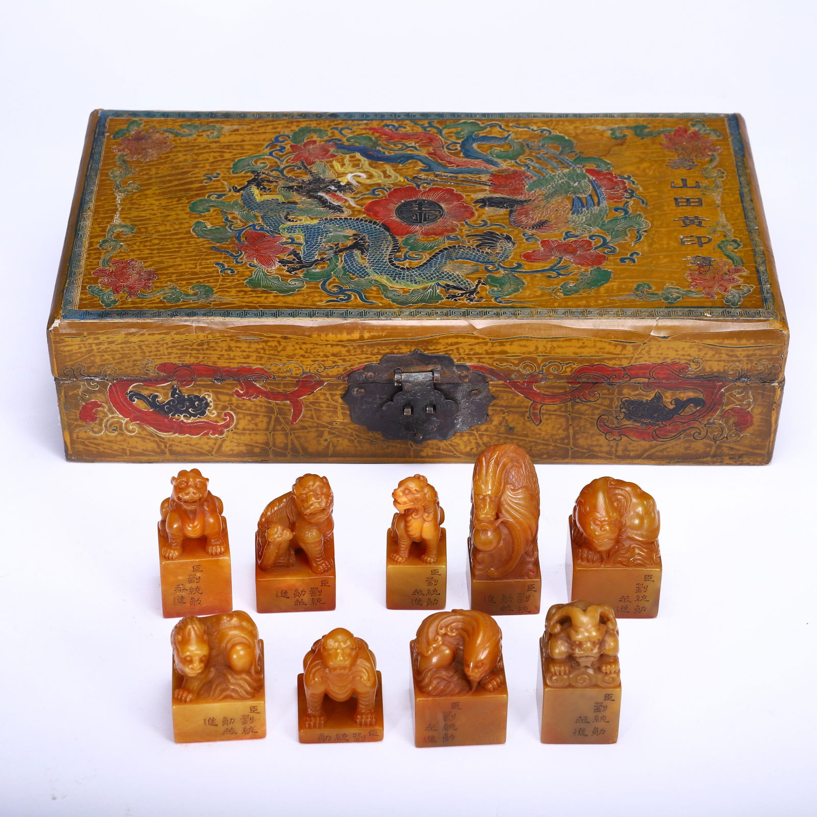 A COLLECTION OF TIANHUANG SEALS: A COLLECTION OF TIANHUANG SEALS This exceptional set of nine Chinese Tianhuang stone seals is presented in an original lacquer box, decorated with vibrant dragon and phoenix motifs. Each seal is