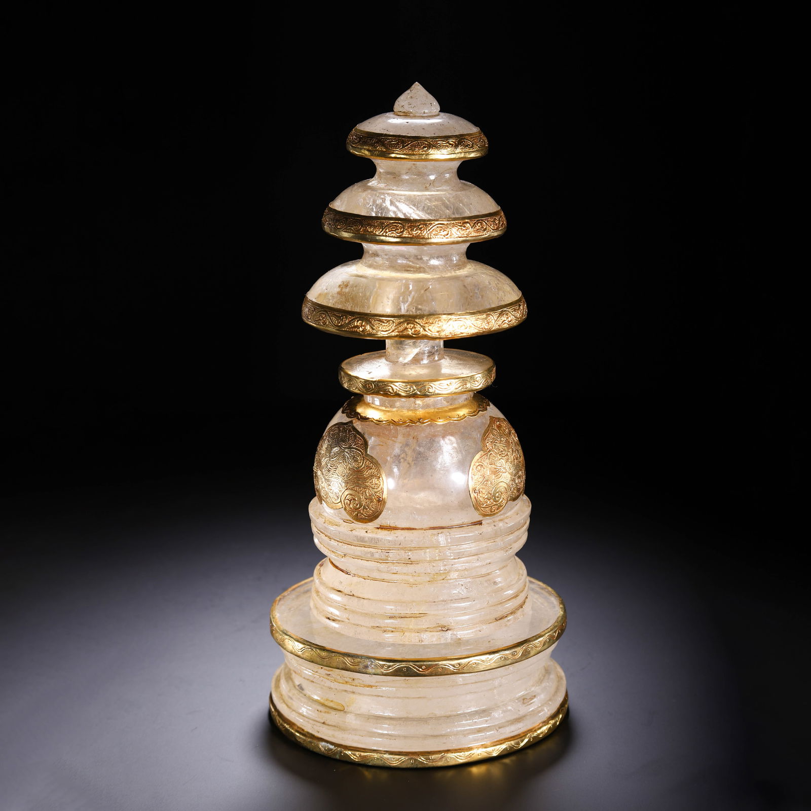A CARVED ROCK CRYSTAL STUPA: A CARVED ROCK CRYSTAL STUPA This Chinese stupa is carved from a single block of clear, translucent rock crystal, with a tiered, stepped base and a domed main body. It is adorned with ornate