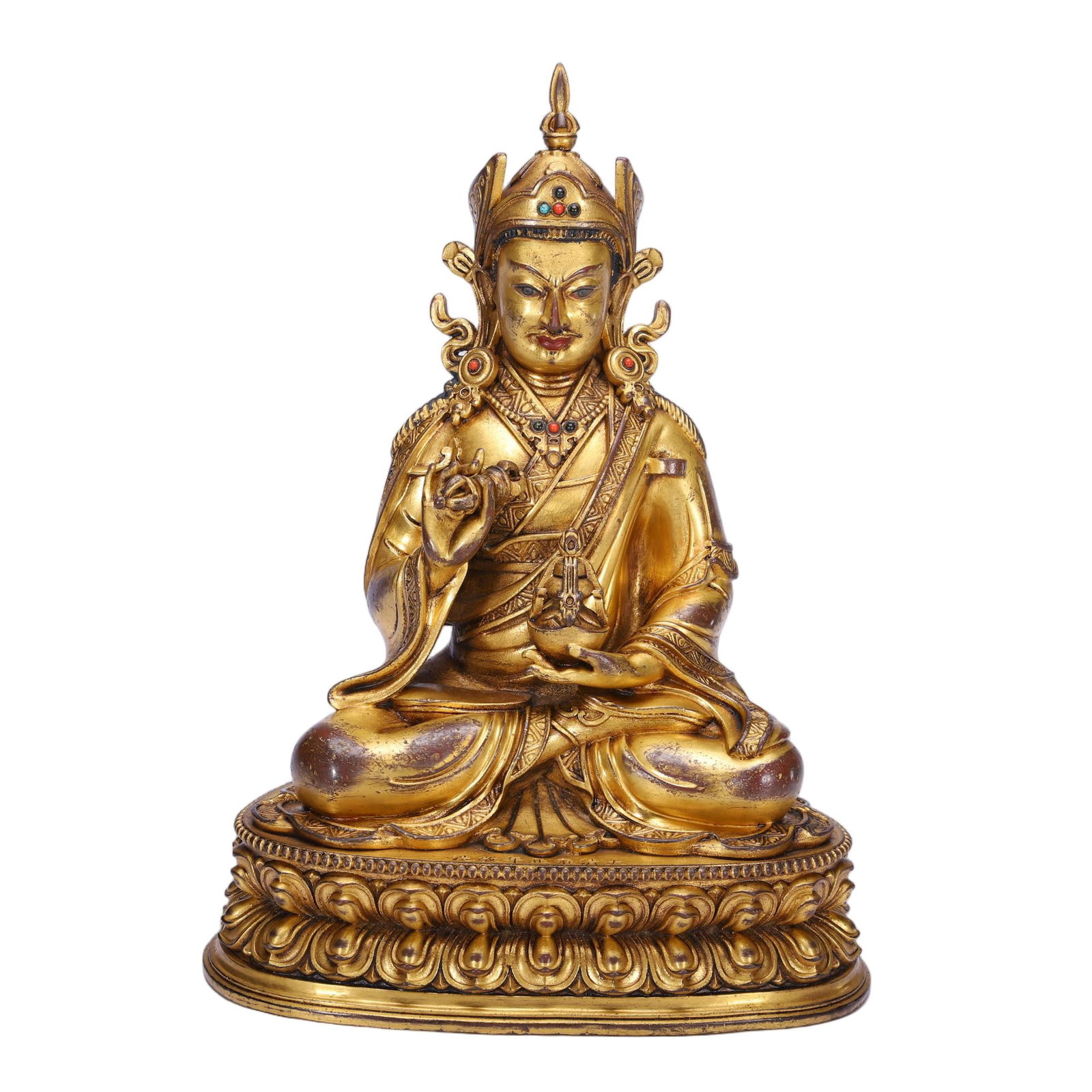 A BRONZE-GILT FIGURE OF PADMASAMBHAVA: A BRONZE-GILT FIGURE OF PADMASAMBHAVA This striking Chinese gilt bronze figure depicts Padmasambhava, the "Lotus-Born" master, seated in a relaxed pose atop a double-lotus base. He holds a vajra in