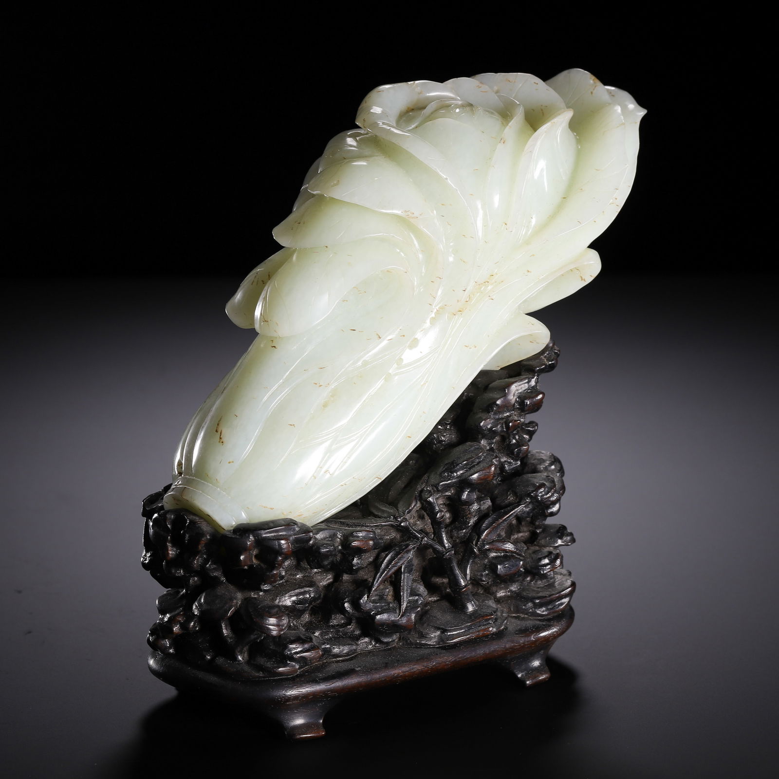 A CARVED WHITE JADE CHINESE CABBAGE PAK CHOI: A CARVED WHITE JADE CHINESE CABBAGE PAK CHOI This Chinese carving is crafted from a single block of fine, milky white Hetian jade, shaped as a cabbage with intricately layered, overlapping leaves.