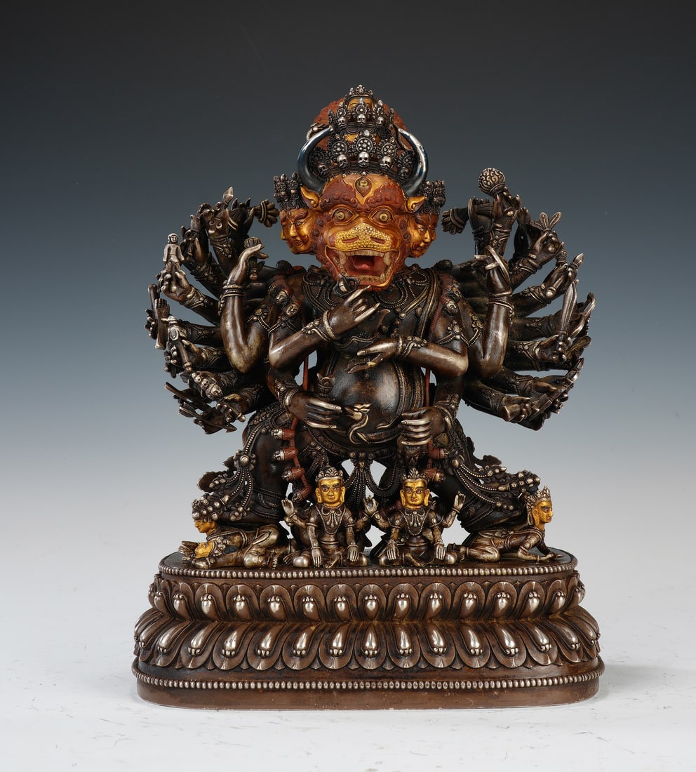 A BRONZE FIGURE OF YAMANTAKA: A BRONZE FIGURE OF YAMANTAKA A powerful and dynamic gilt-bronze figure of Yamantaka, the "Destroyer of Death," a principal protector deity in Tibetan Buddhism. The wrathful deity is depicted with a fe