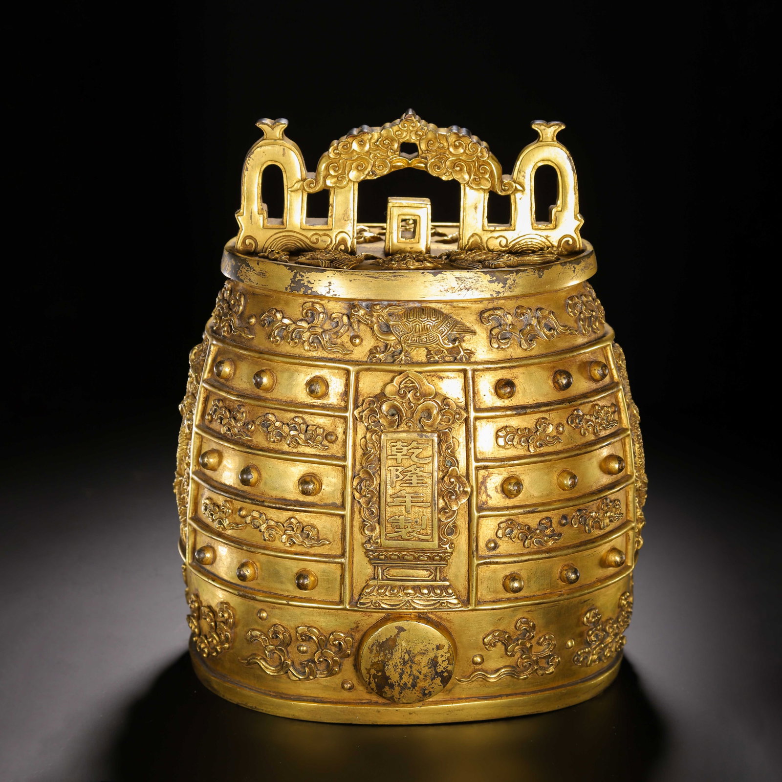 A Chinese Gilt Bronze Bianzhong Bell: A Chinese Gilt Bronze Bianzhong Bell This Chinese gilt bronze bianzhong bell measures 20 cm in length, 16 cm in width, 25 cm in height, and weighs 10380 grams. It features an ornate arched suspension 