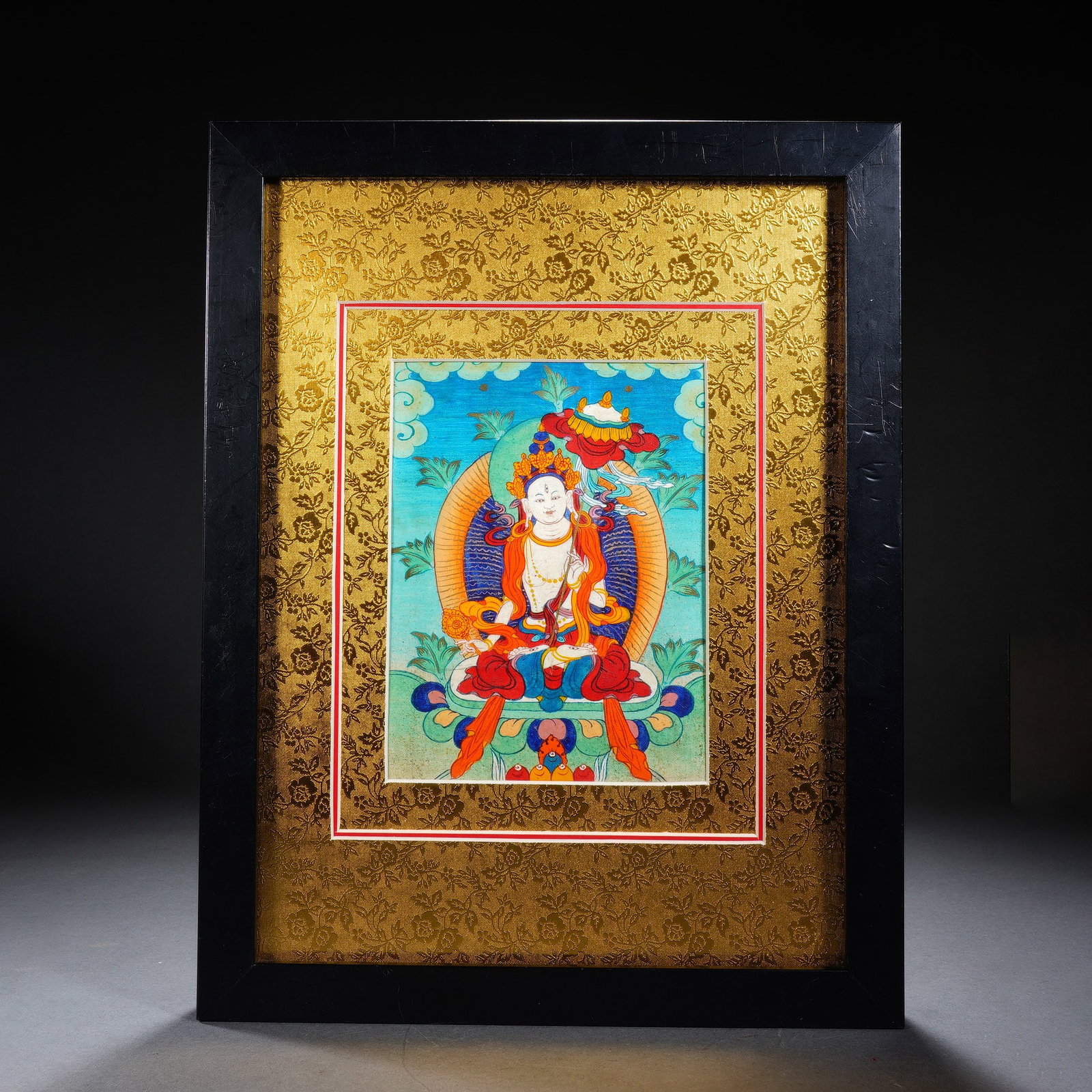 Chinese White Tara Thangka: Chinese White Tara Thangka This framed Chinese thangka depicts White Tara seated in meditative pose, rendered with vivid pigments in traditional Tibetan Buddhist style. The deity is adorned with richl