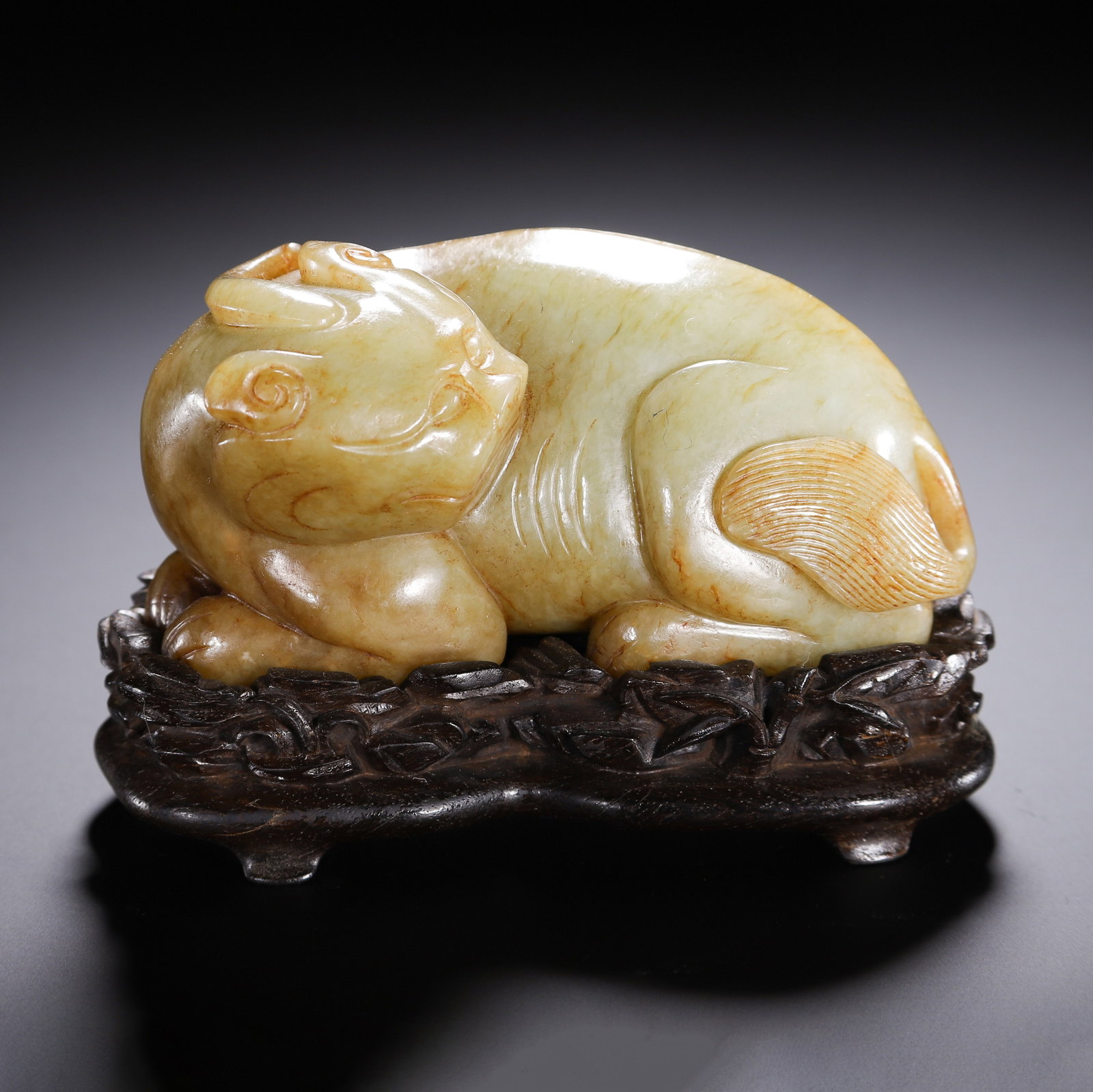 A Chinese Yellow Jade Mythical Beast: A Chinese Yellow Jade Mythical Beast This finely carved Chinese yellow jade mythical beast ornament measures 10.5 cm in length, 5.5 cm in width, 6.5 cm in height, and weighs 520 grams. The recumbent b