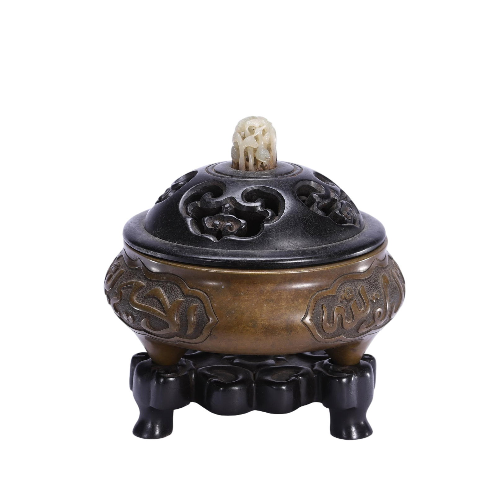 A Chinese Bronze Tripod Censer with Hardwood Lid and Jade Finial: A Chinese Bronze Tripod Censer with Hardwood Lid and Jade Finial This elegant tripod censer measures 14 cm in length, 14 cm in width, 15 cm in height, and weighs 1690 grams. The bronze body features r