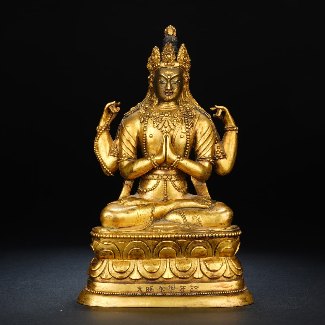 Chinese Gilt-Bronze Four-Armed Chenrezig Statue: Chinese Gilt-Bronze Four-Armed Chenrezig Statue This exquisite gilt-bronze statue depicts the four-armed Chenrezig (Avalokiteshvara), seated in padmasana atop a detailed double-lotus pedestal. The Bod