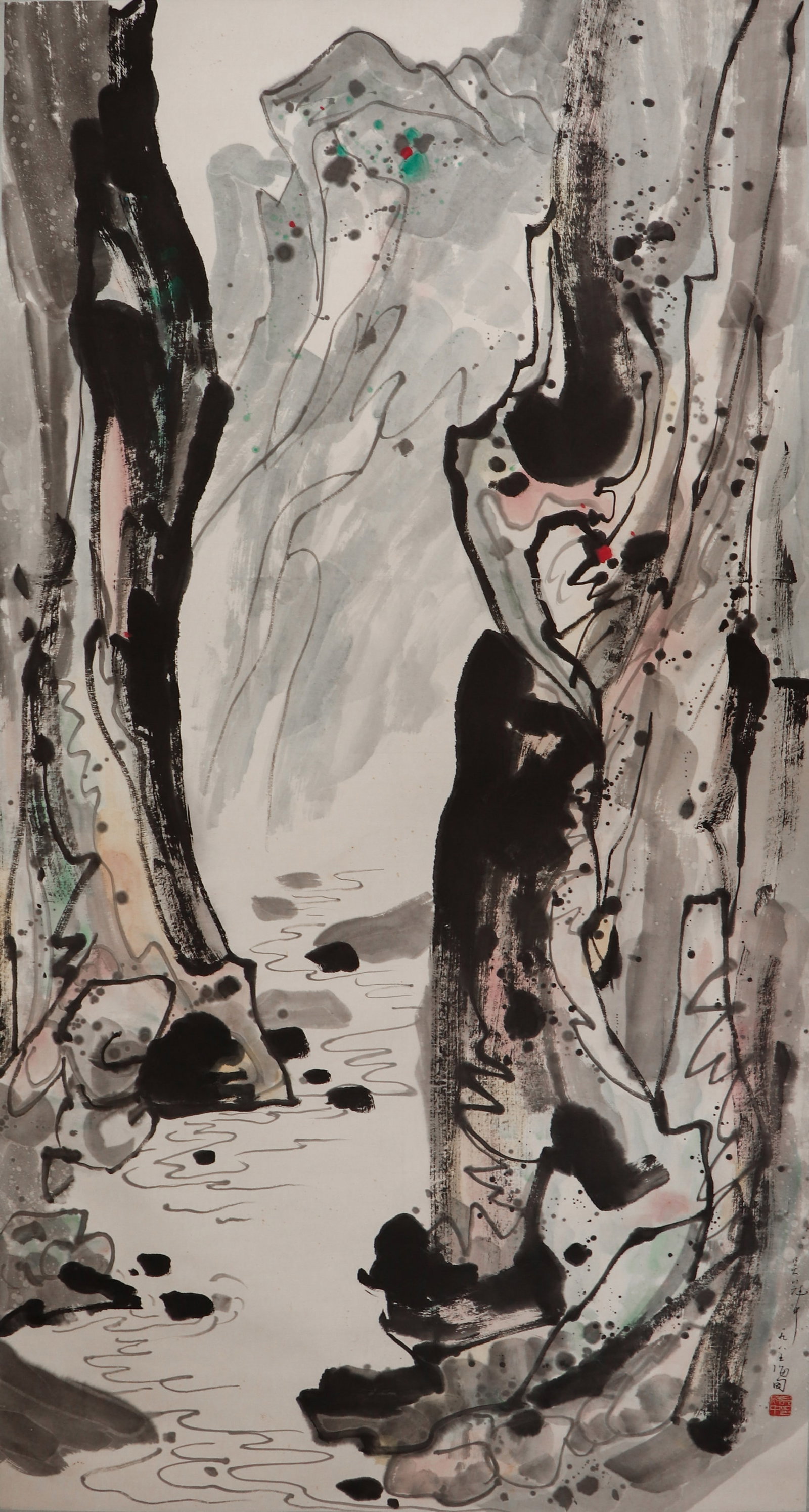 A CHINESE PAINTING OF LANDSCAPE SIGNED WU GUANZHONG: A CHINESE PAINTING OF LANDSCAPE SIGNED WU GUANZHONG This hanging scroll, ink and colour on paper, measures 178 x 94 cm. Attributed to Wu Guanzhong, it depicts a dramatic canyon landscape in his signat