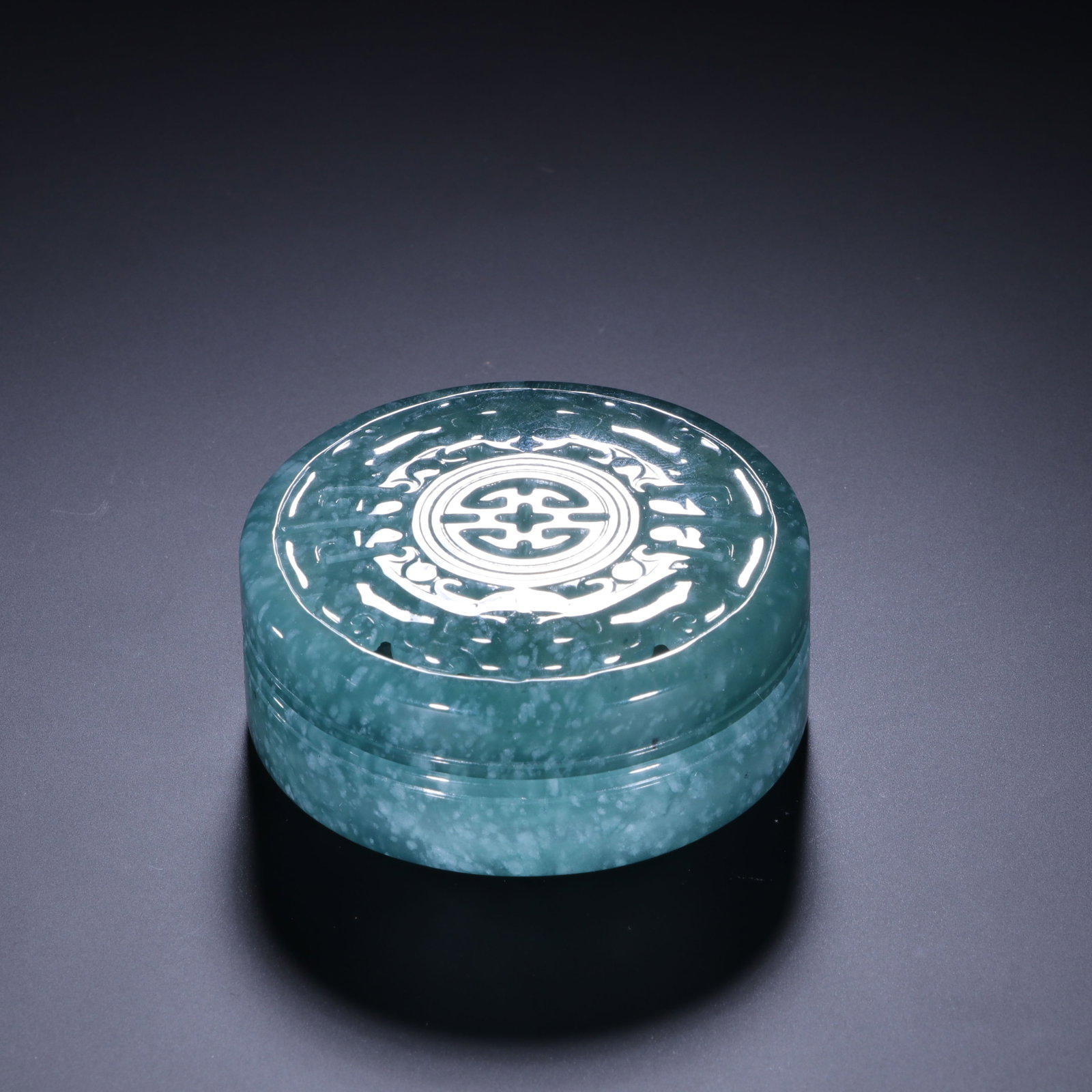 A Chinese Carved Jadeite Incense Burner: A Chinese Carved Jadeite Incense Burner This exquisite jadeite incense burner measures 2.3 cm in height and 5.5 cm in width. The round, shallow vessel is crafted from translucent blue-green jadeite wi