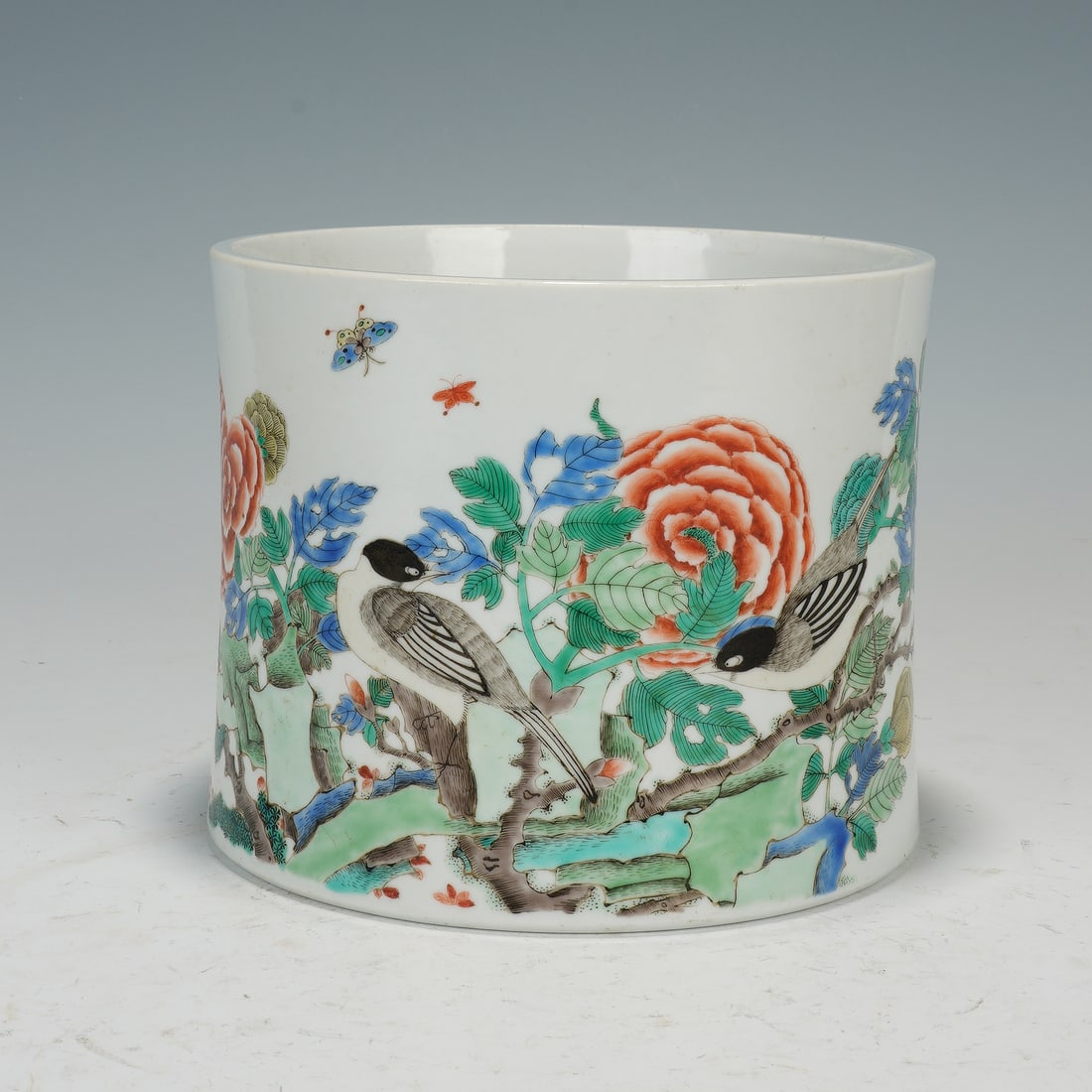 Chinese Wucai Porcelain Bird-and-Flower Brush Pot: Chinese Wucai Porcelain Bird-and-Flower Brush Pot This elegant cylindrical brush pot is crafted from fine white porcelain and adorned with vibrant wucai enamels. The exterior depicts a lively scene of