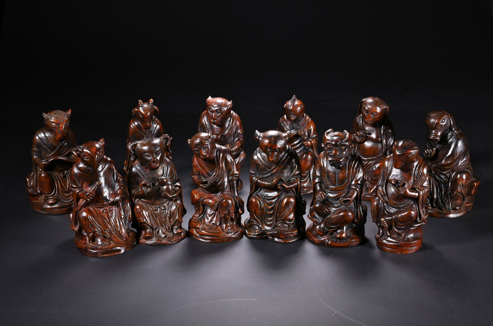A Set of Chinese Bamboo Carved Twelve Zodiac Figures: A Set of Chinese Bamboo Carved Twelve Zodiac Figures This complete set of twelve zodiac figures, each measuring 11.5 cm in height and 6.5 cm in width, is expertly carved from aged bamboo. Each figure 