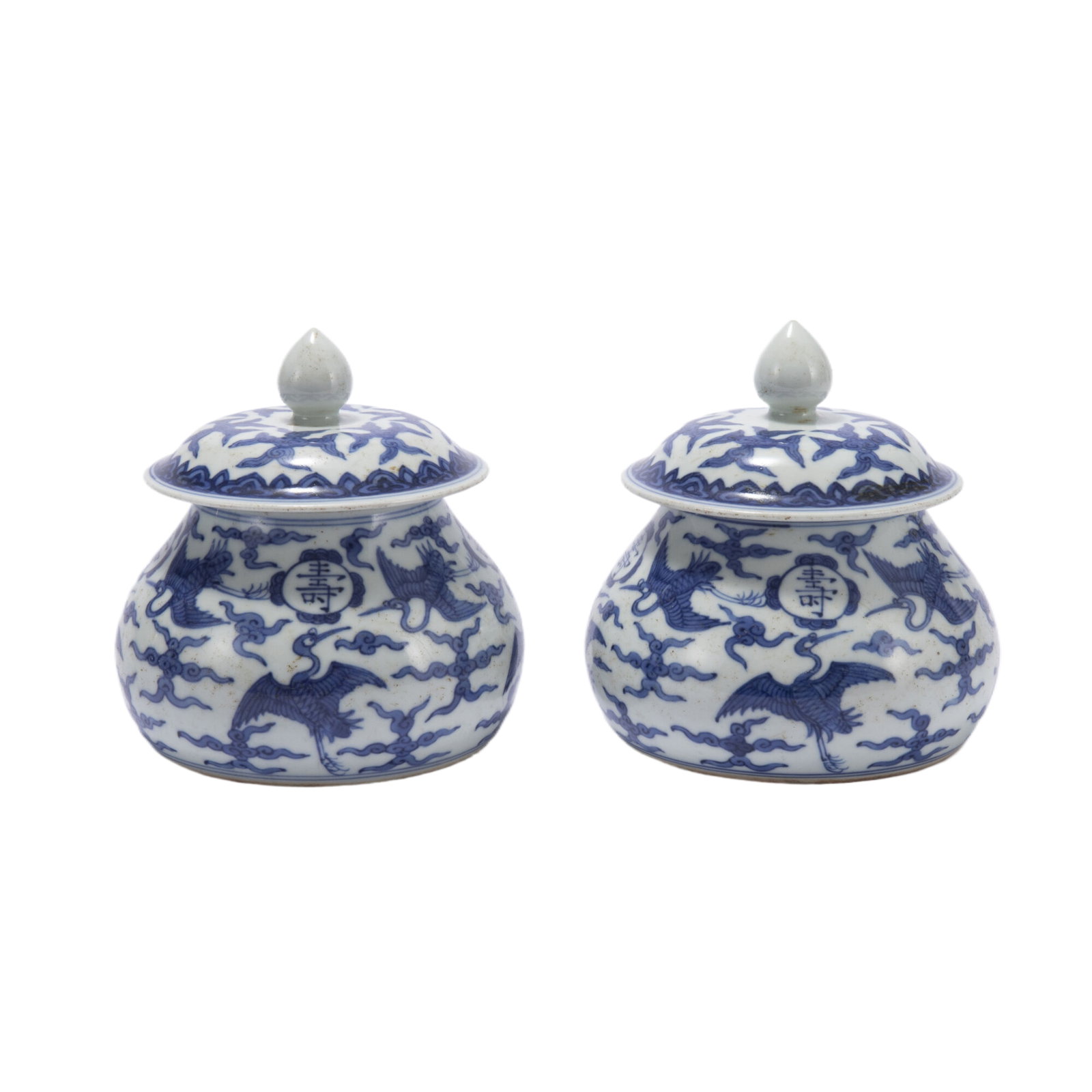PAIR OF BLUE AND WHITE PORCELAIN LIDDED JARS: PAIR OF BLUE AND WHITE PORCELAIN LIDDED JARS Of wide squat baluster form, painted cranes amidst clouds in blue and white, with dome cover ended a conical finial. DIMENSIONS: Diam. 11.5 cm. H. 11.5 cm.