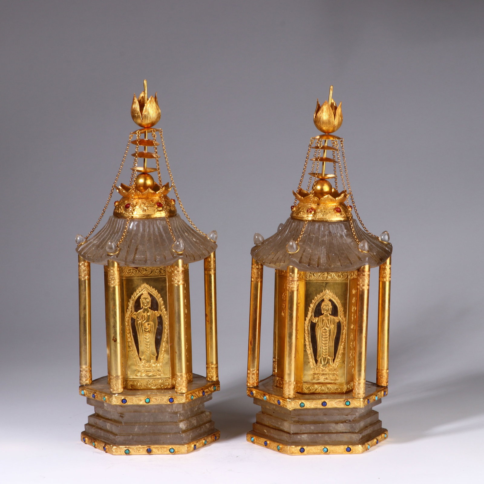 A Pair of Chinese Rock Crystal and Gilt-Bronze Reliquary Stupas: A Pair of Chinese Rock Crystal and Gilt-Bronze Reliquary Stupas This exquisite pair of stupas, each measuring 36 cm in height and 14 cm in width, are crafted from carved rock crystal and gilt bronze. 