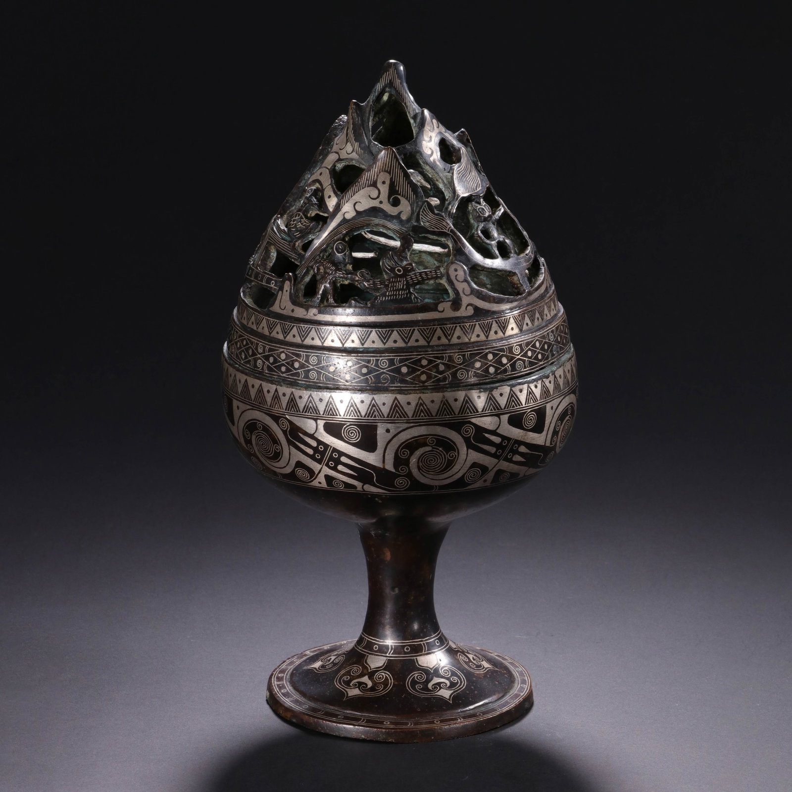 A Chinese Silver-Inlaid Bronze Boshanlu Censer: A Chinese Silver-Inlaid Bronze Boshanlu Censer This Chinese silver-inlaid bronze censer measures 22 cm in height and 11.5 cm in width. Crafted in the traditional Boshanlu mountain-form style, the open